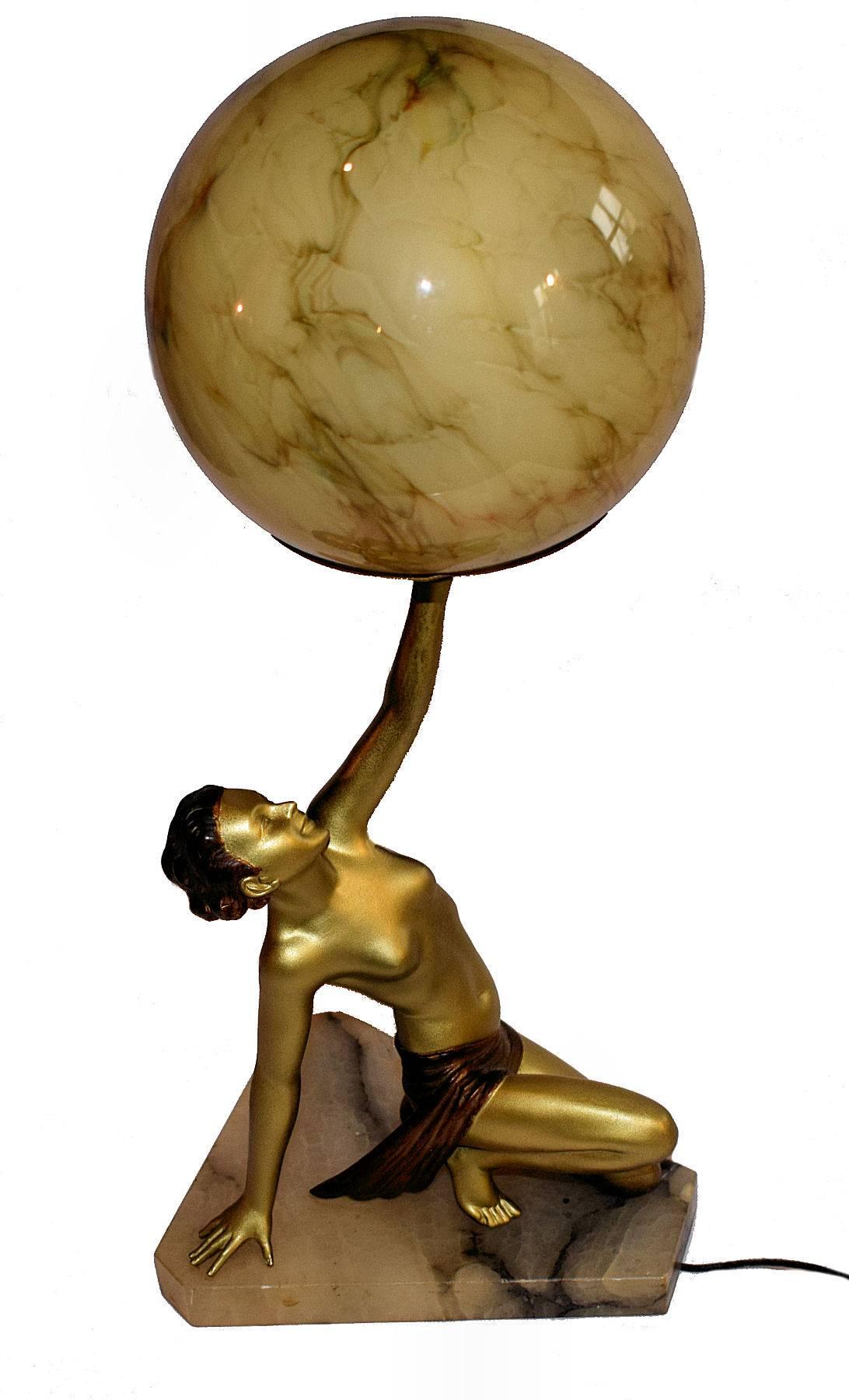 A really nice original Art Deco lady lamp, circa 1930.
Standing on an alabaster base she stands 12 inches without the shade and 16 inches with it. Made from spelter and cold painted she has minimal wear. The original amber marbled effect globe is