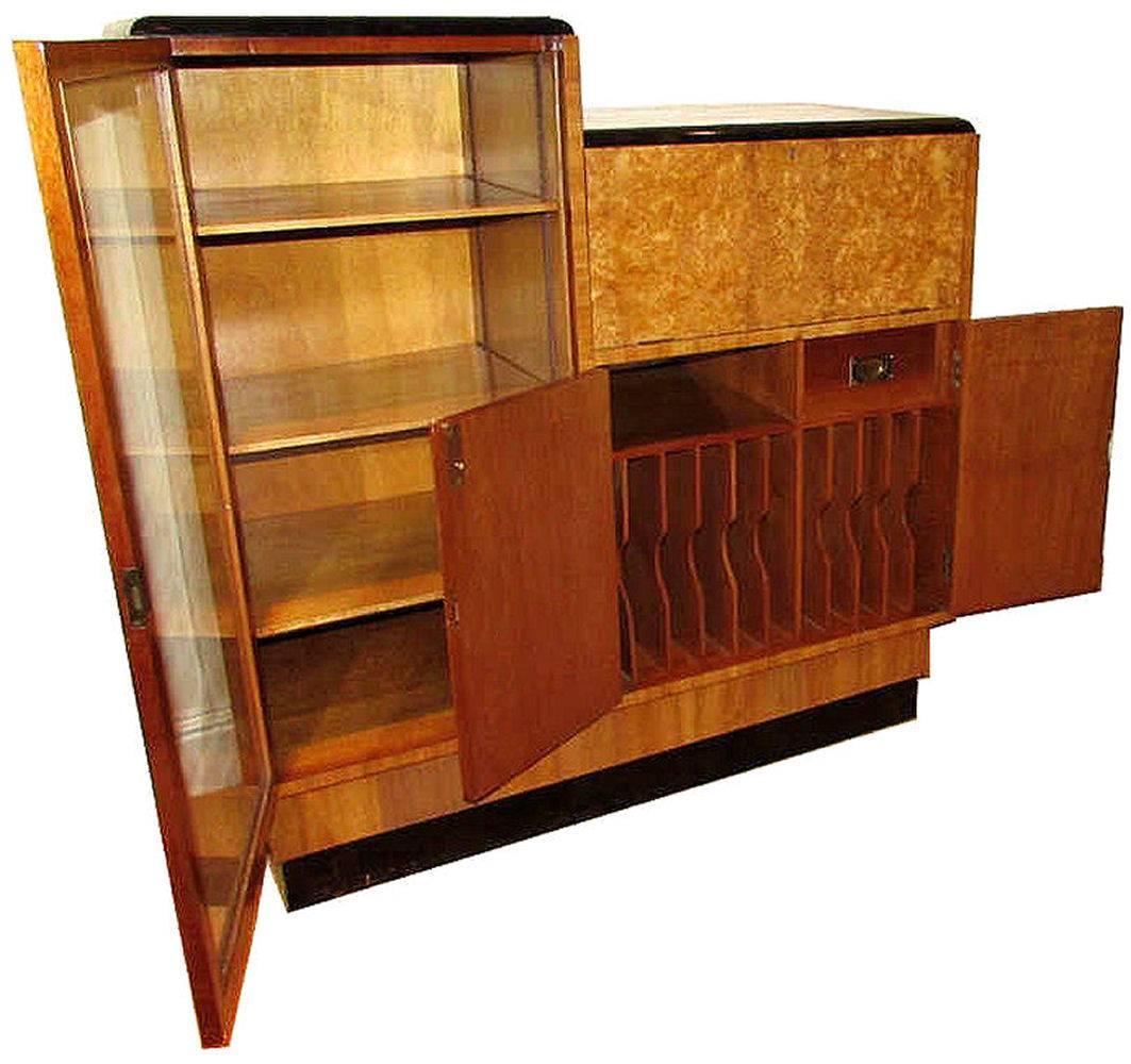 Very impressive 1930s Art Deco blonde burr walnut secretaire. Large glass full height door to the left side with fully height adjustable shelving inside. To the right side is a lockable drop down door which becomes a writing desk with leather inset