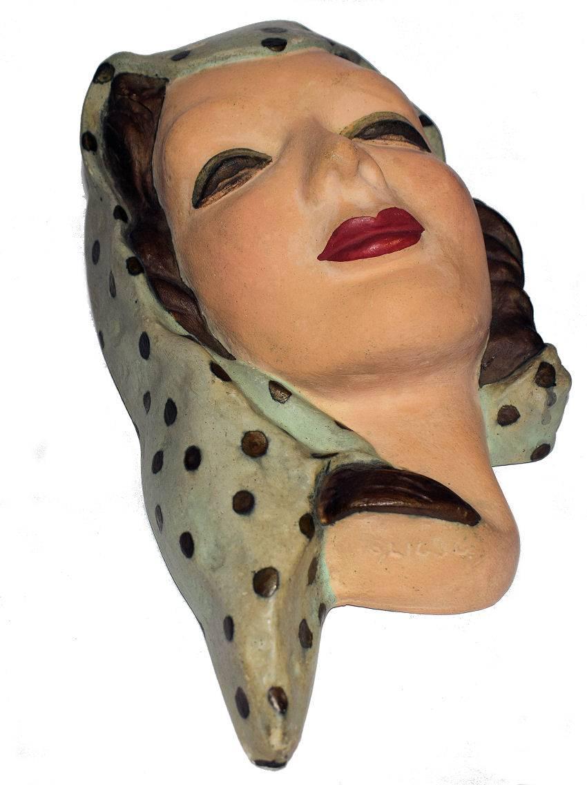 Rare and usual 1930s wall mask in ceramic and glazed finish. Very large and a style we've not had before, she's hollowed on her back and has a single hook to hang from. There is a registration number but it's not discernible. Her colouring is as