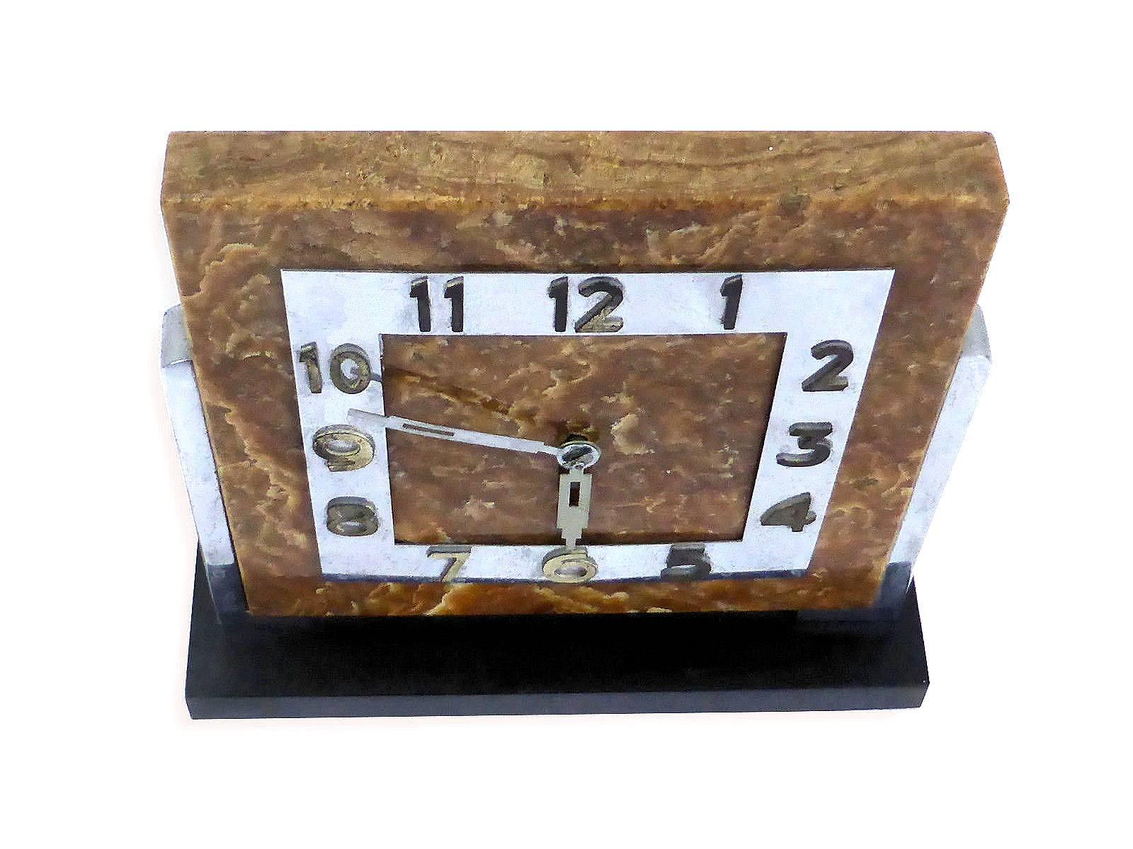 Impressive 1930s modernist clock originating from Germany. The base is black slate marble and the face is Onyx with a chrome frame. Great sized clock, ideal for mantel or desk.