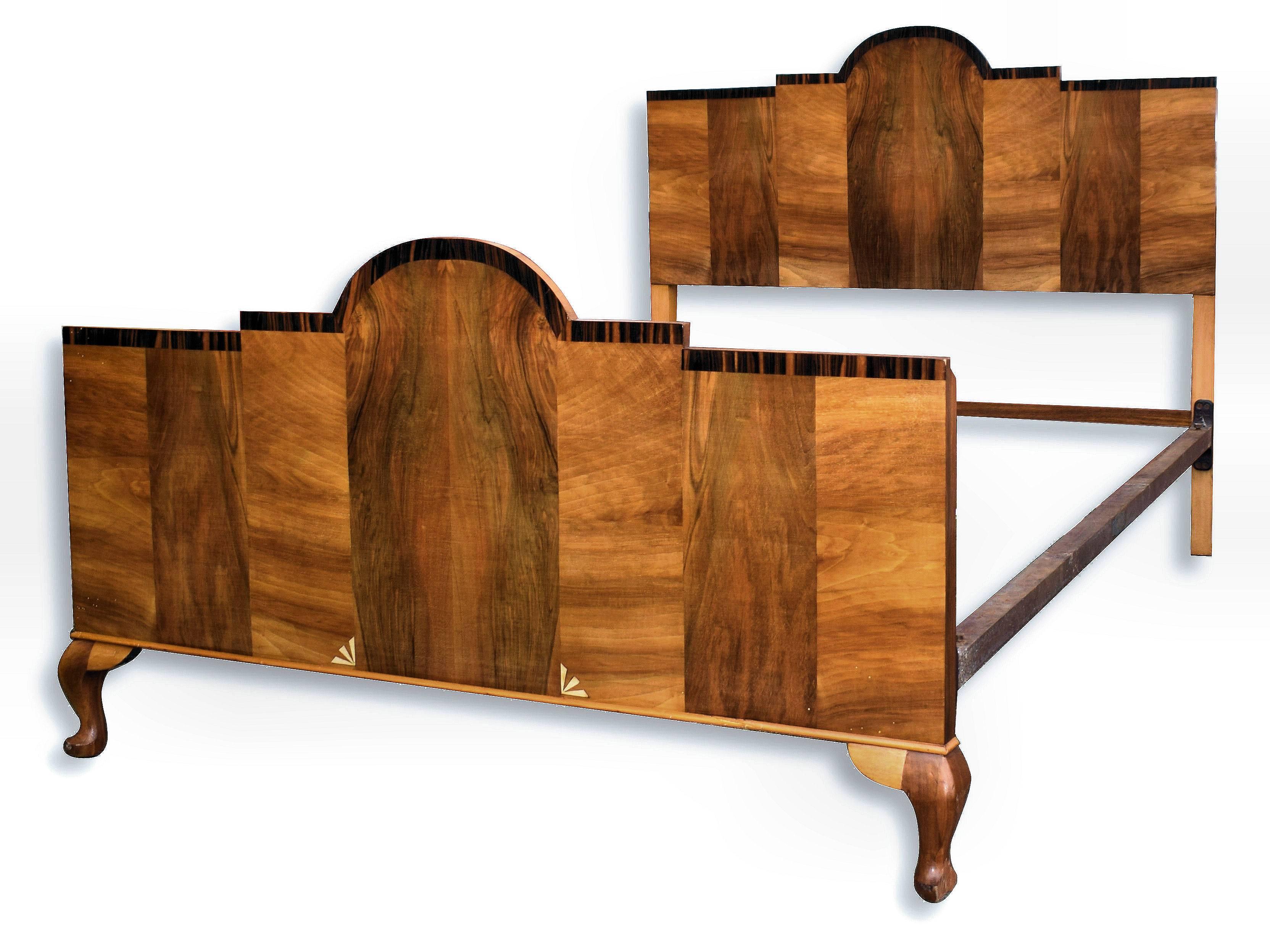 For your consideration is this fabulous and totally original 1930s Art Deco English double bed. The shape of the bed is very odeonesque and is accentuated by the outline border of Macassar veneers. The walnut veneered panels work beautifully and