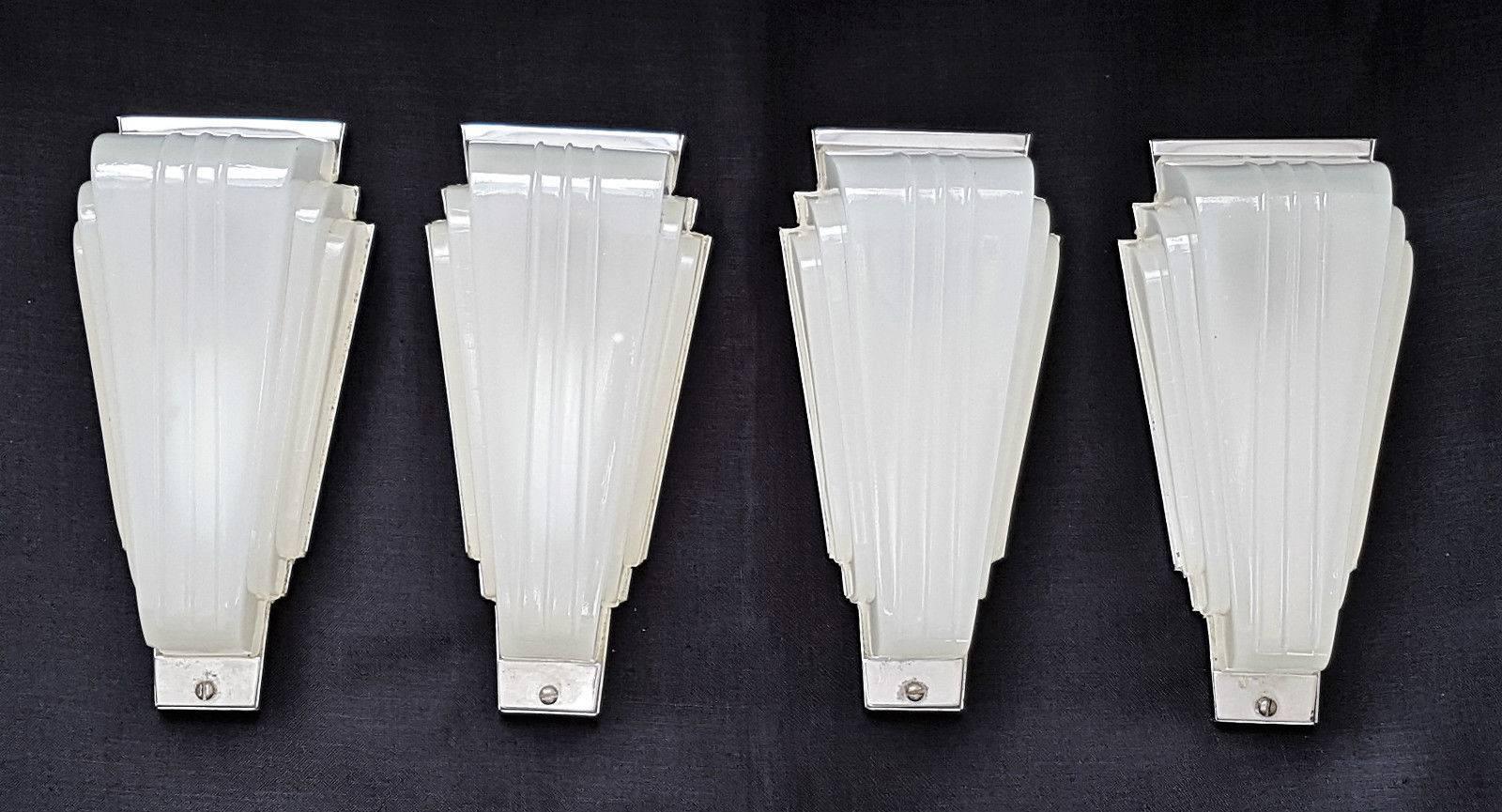 Four 1930s original Art Deco, frosted glass and chrome metal wall lights. They are Classic Art Deco Cinema type design, with a beautiful stepped shape in thick Opaque glass. They date to 1932 their original brown bakelite insulators/bayonet type
