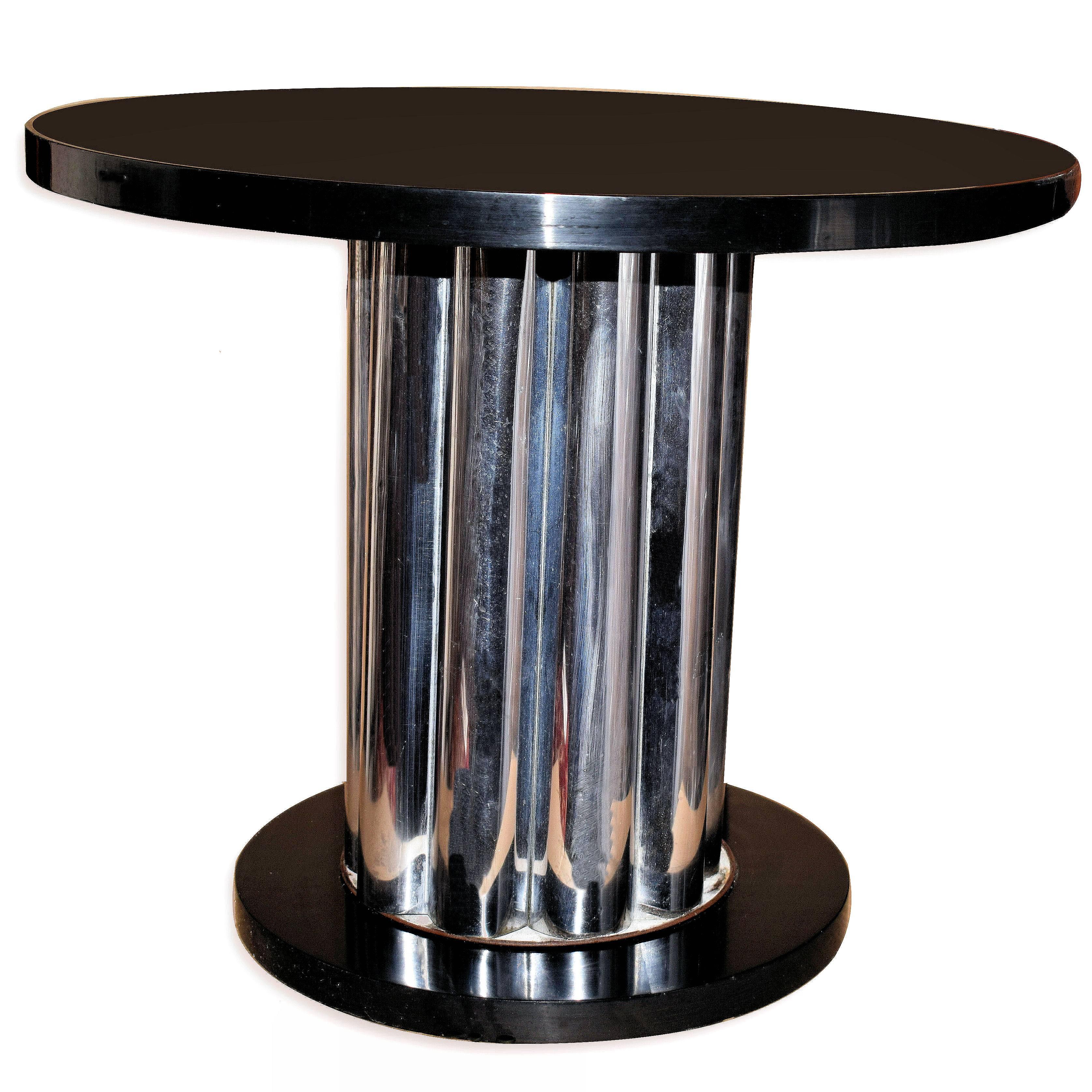 A table with the wow factor is this totally authentic Art Deco modernist table dating to the 1930s. Features a very highly polished ebonized top with a drum column which made up from corrogated chrome panels, all of which sits on a circular ebonized