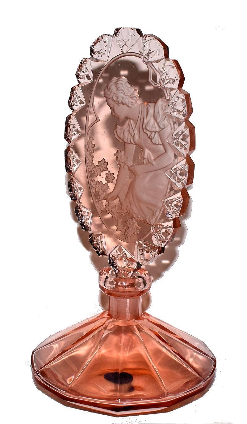 A gorgeous Art Deco style perfume bottle expertly handmade in the Czech Republic . This unique bottle is completely handcrafted. The flacon is hand-carved from a very expensive peach or topaz colored alexandrite crystal and depicts a 1930's female