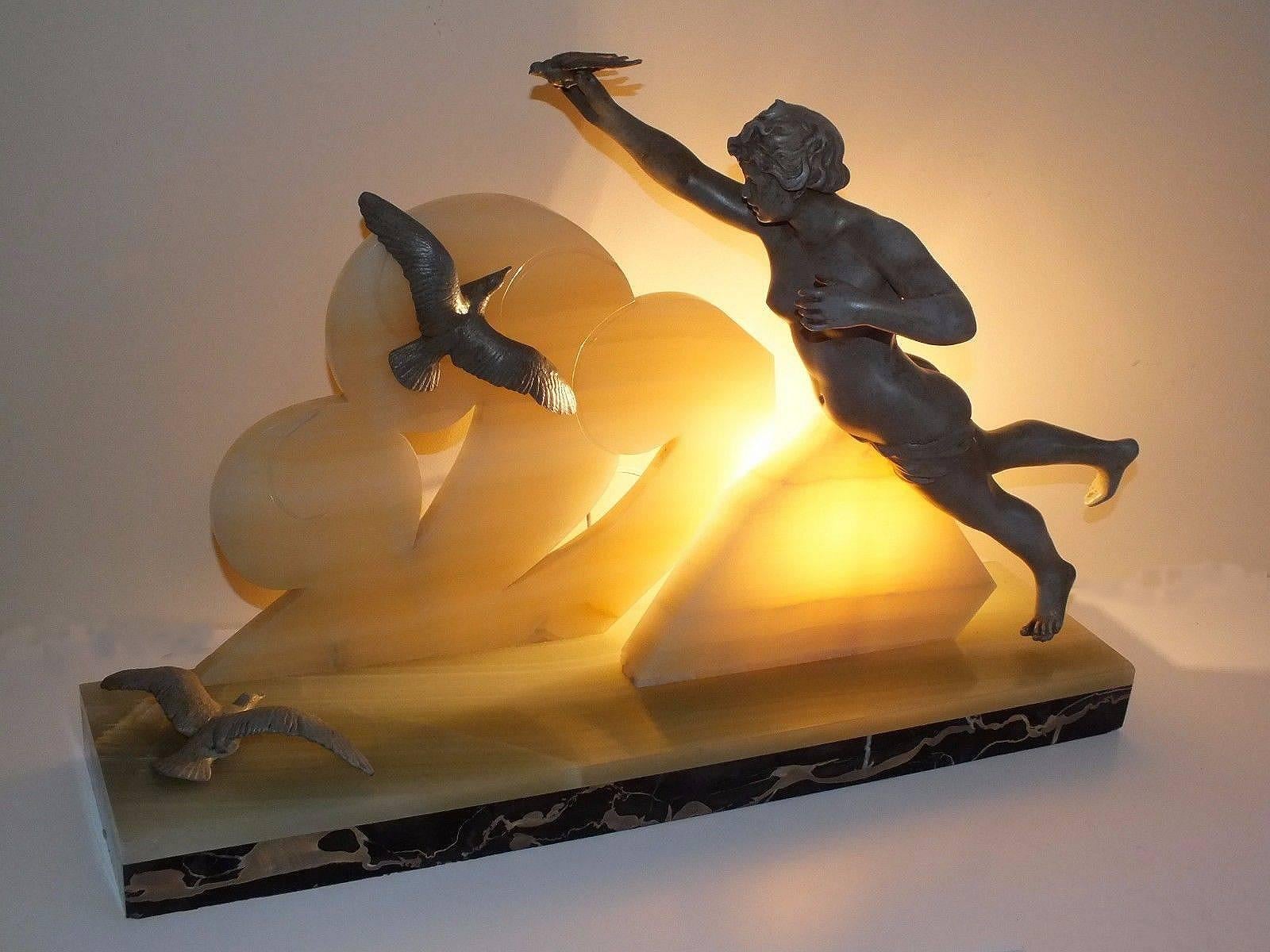 Totally authentic 1930s Art Deco French figural lamp decorated with a muse and birds. The base is in solid marble and onyx with the figures made from spelter. The whole piece is in superb condition and very beautiful and would nothing less than