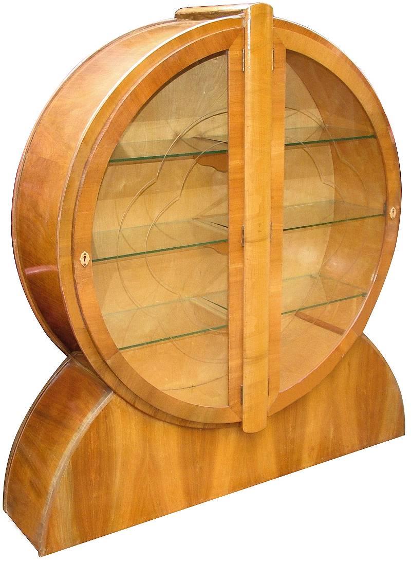 Iconic circular period 1930s Art Deco display cabinet with three internal glass shelves with lots of storage to display your collection. The original etched glass door panels are cut in the form of a flower head / cloud shape. This cabinet is one of