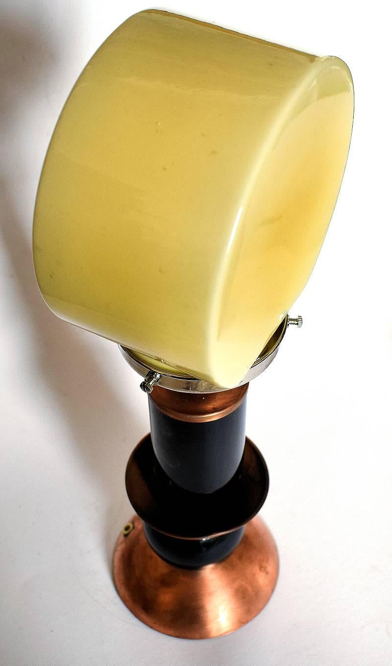 Wonderfully stylish and iconic in its styling is this modernist table lamp dating to the 1930s. Originates from France and features a sepia toned glass circular shade which sits upon a chrome gallery and alternated copper and black glass segmented