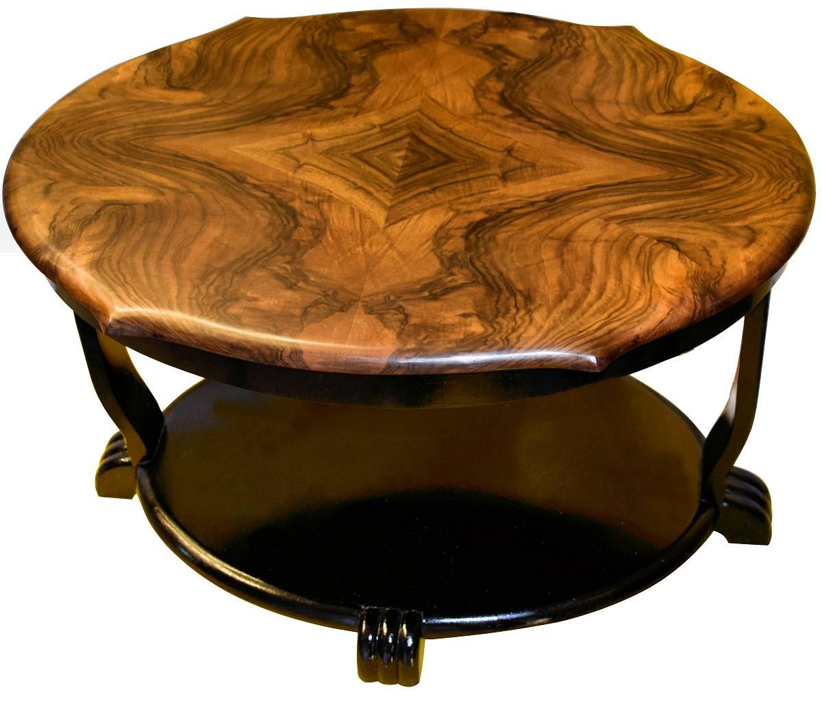 Art Deco coffee table dating to the 1930s with a beautifully quartered book-paged figured veneered walnut top. The rest is ebonised with reeded legs and feet. Having been newly restored this is in excellent condition.