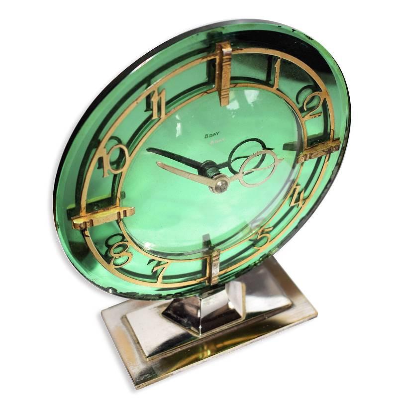 Very attractive 1930s Art Deco Modernist clock by English clock makers 'Smiths'. Eight day wind up movement with a gentle tick and keeps good time. Features a lovely deep green mirrored dial face with gilt numerals and hands all of which is