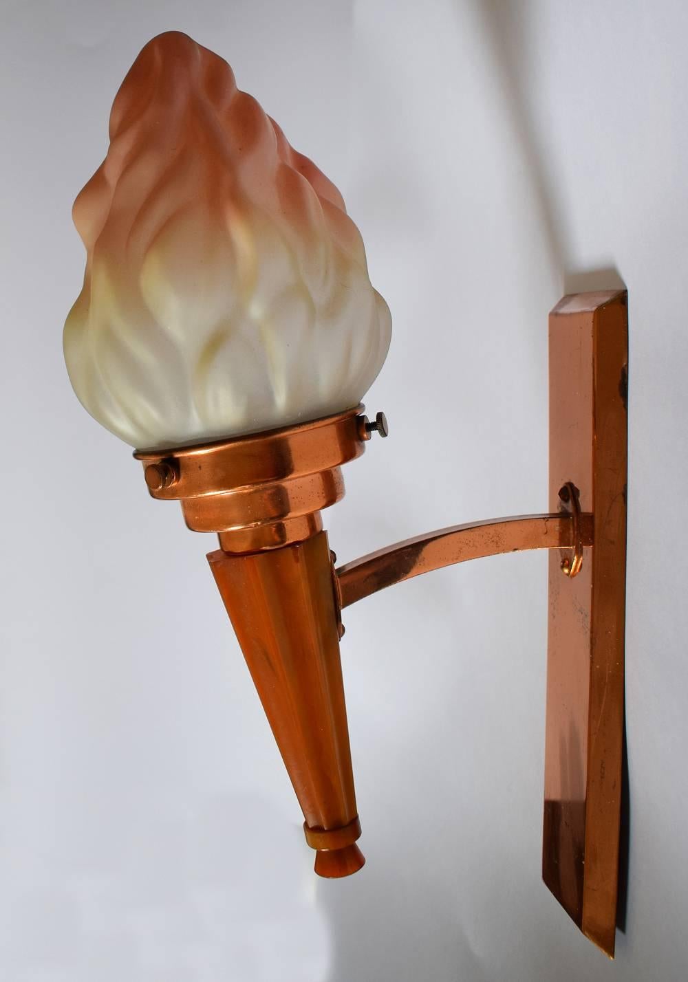 Very attractive 1930s Art Deco pair of English matching wall lights. These high style wall lights feature a single arm catalin bakelite stem, copper back plate with frosted tinted glass flame shade. These lights look as impressive switched on or off.
