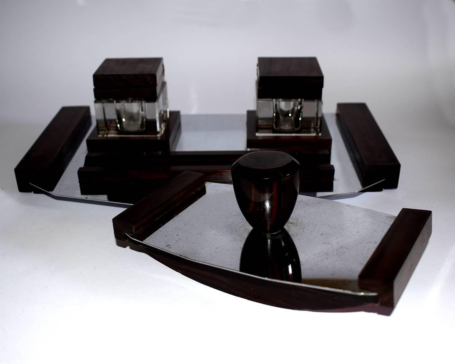 Originating from France this superb 1930s Art Deco desk set comprises a blotter and a freestanding tray which holds two inkwells, and a pen tray. The whole piece is adorned with Massacre ebony wood accents. This desk set has man cave written