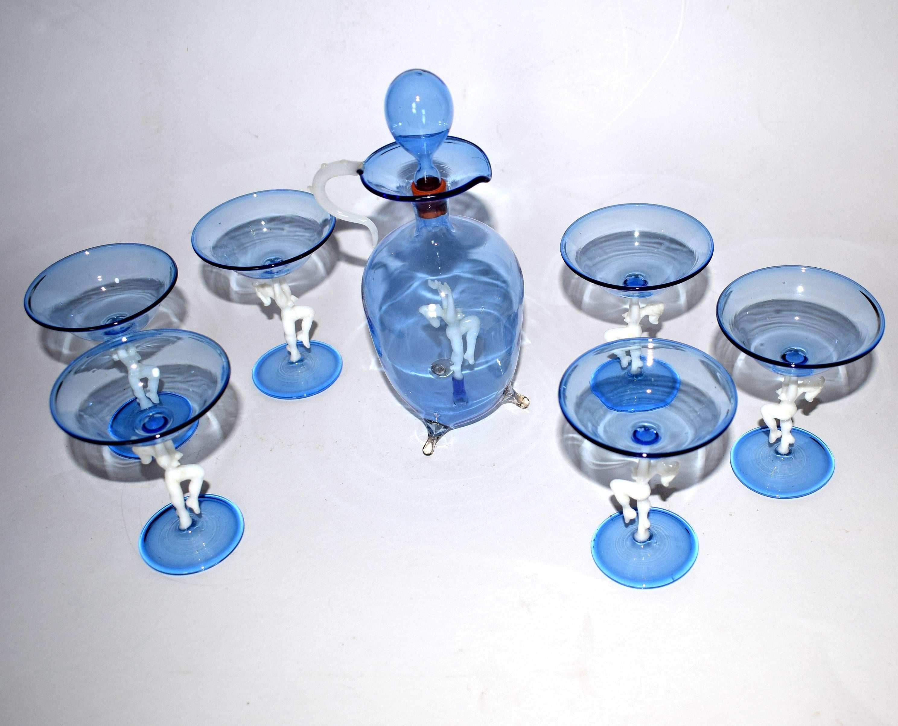 A slightly cheeky Art Deco decanter set with matching set of six glasses in handblown blue glass, in the style of Bimini. The stems designed as nude ladies. Very delicate to touch and amazing that something like this last all these years. This