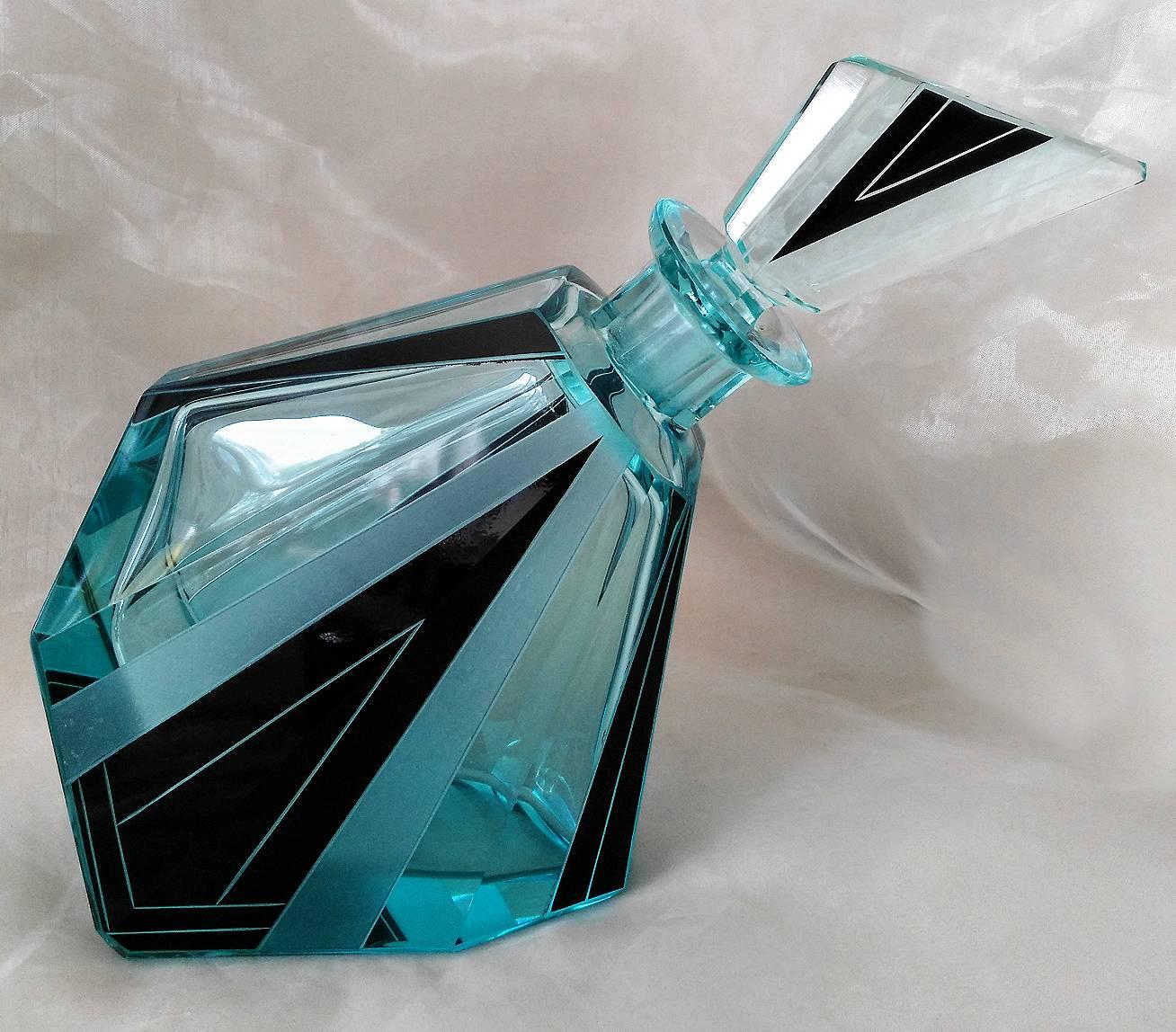 Wonderfully quirky and stylish Glass decanter set by Karl Palda. Geometric enamelling decorate the attractive turquoise crystal, stunning shape and cut, small shot glasses. Comprises decanter and stopper with six glasses. Condition is excellent no