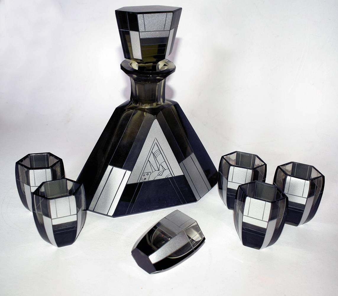 For those with a taste for the rare and desirable we are pleased to be able to offer you for your consideration this rare Art Deco decanter set by Karl Palda. Dating to the 1930s this high style set is in deep green, almost black heavy cut-glass.