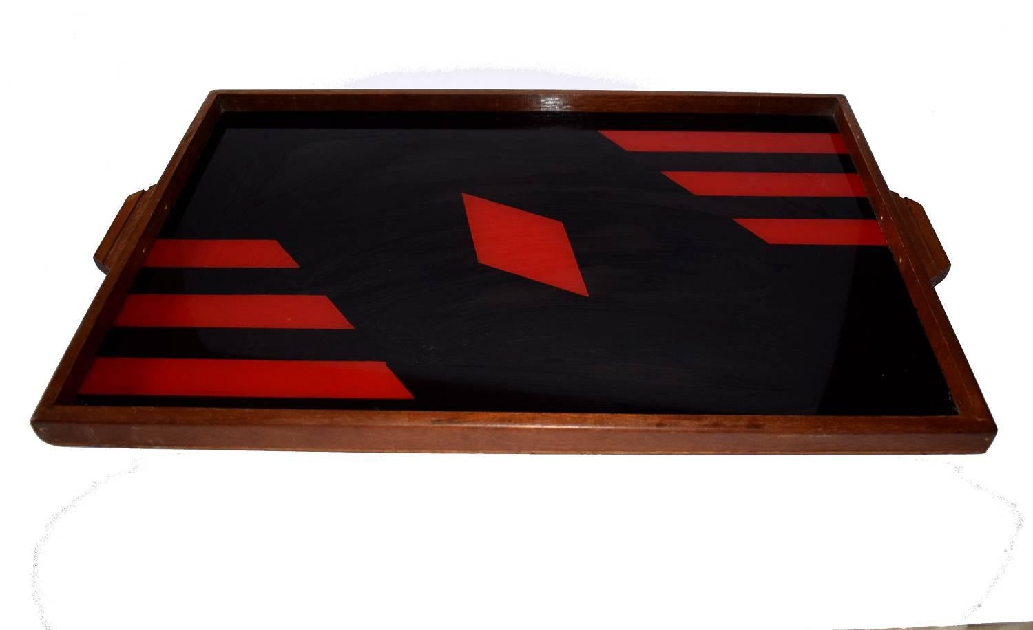 Very stylish and striking item is this Art Deco serving tray with a stark, geometric design in red and black on a reflective glass base with a wooden surround. A nice size for modern day use should you so wish or just as display to go with your Art