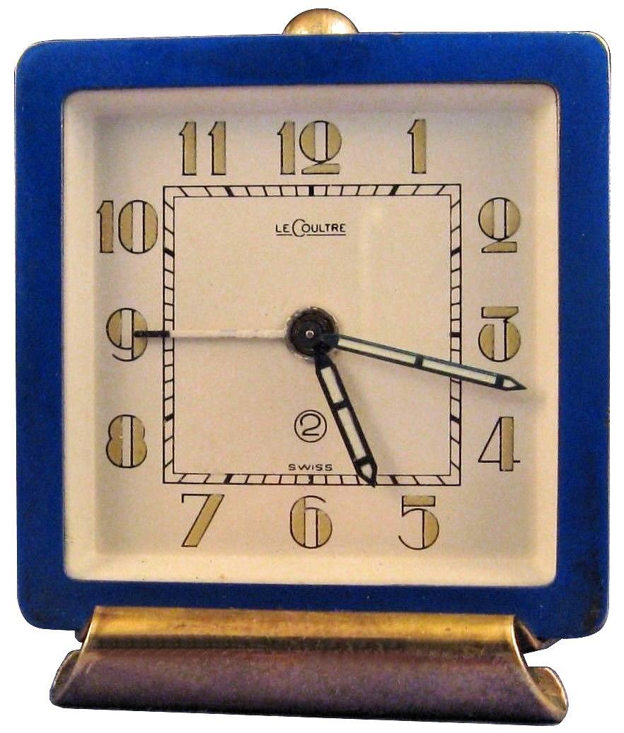 This is for a beautiful original and extremely stylish art deco desktop alarm clock made by Jaeger LeCoultre. It dates to the 30s, it has a 2 day movement and it has a blue enamel body with a gilded stand and stylised art deco numerals. The face is