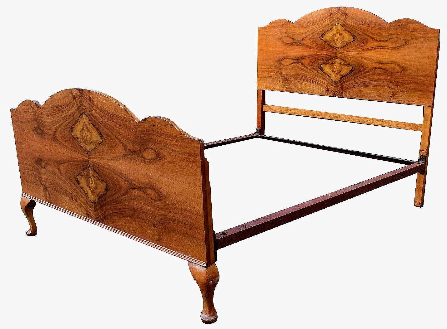 Very attractive 1930s, English walnut double bed. Book paged veneers look superb on the scalloped shaped headboard and foot-board . Standard double size, so ideal for modern use. Mid tone walnut coloring so easily integrates with any styled bedroom.