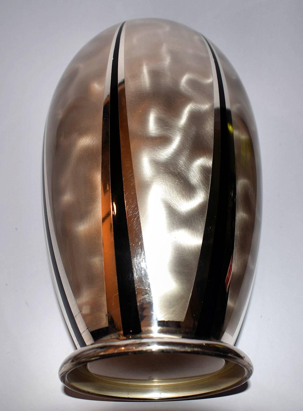 Very stylish Art Deco WMF Ikora vase designed in 1934. The black stripes in the decor are inlay enamel. You can find this design in a WMF Ikora catalog dated about 1934. Signed with the manufacturers mark and Ikora Silver plate Germany. In lovely