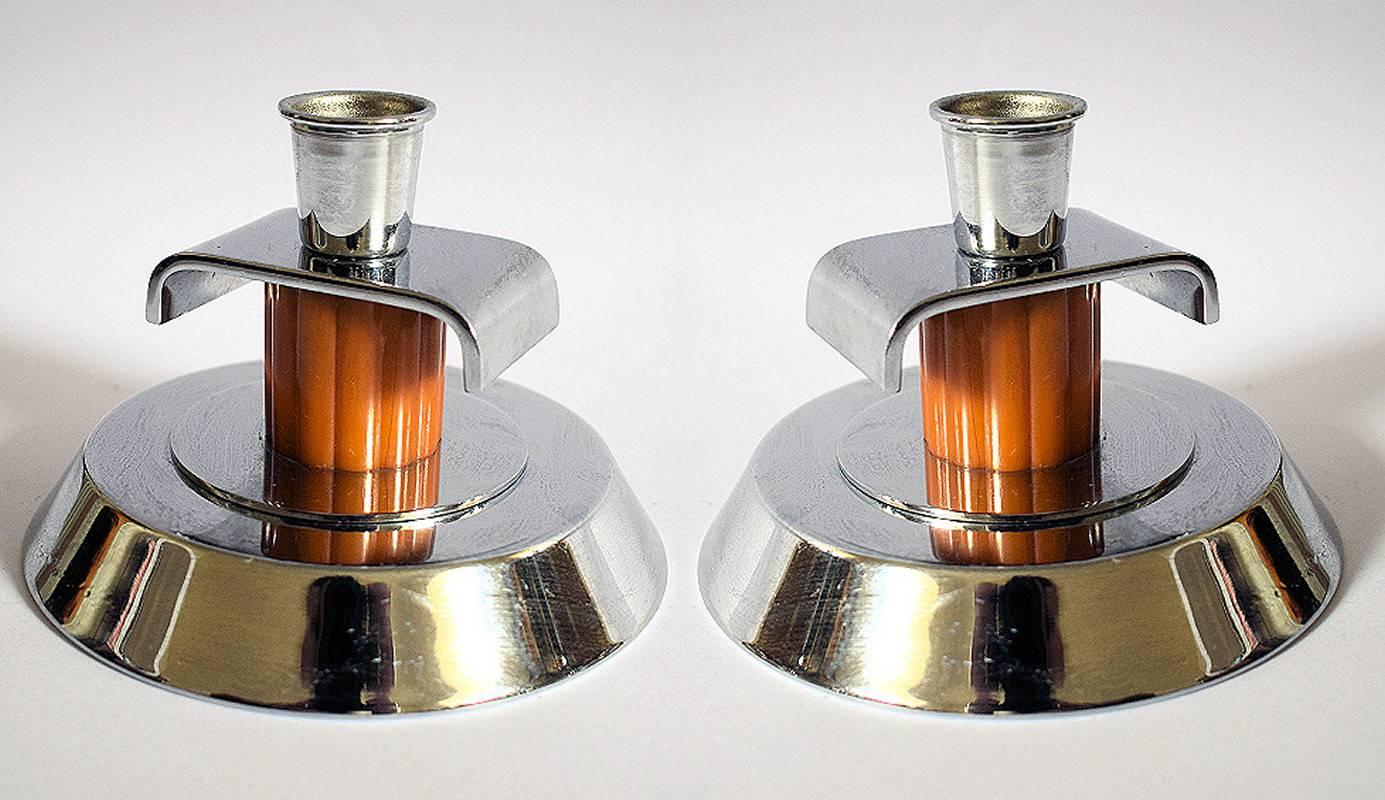 For your consideration are these matching pair of 1930s Art Deco candlesticks. Both are the mirror of each other and originate from England. The feature a weighted chrome circular base with a catalin / phenolic bakelite ribbed column with a chrome