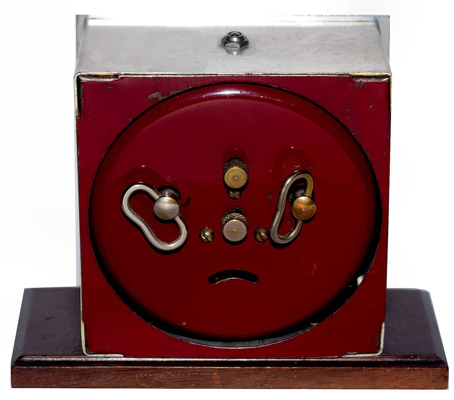 One of my personal favourite makers of French clocks is this clock by Blangy. The stylized numerals are the epitome of Art Deco. The whole body of the clock is chrome which rests on a Mahogany plinth and has a burgundy colored back cover.
The dial