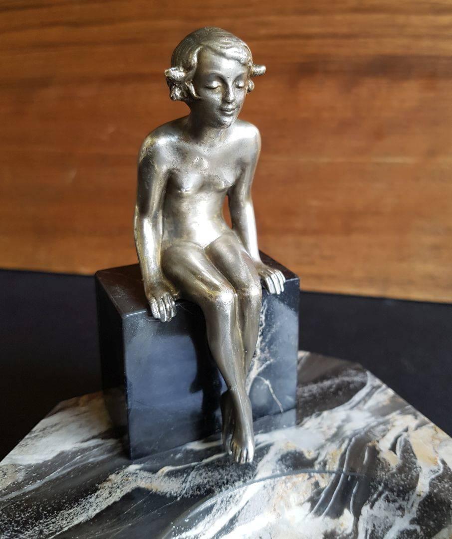 Lovely little Austrian bronze of a nude young girl sat on the side of a vide poche, not signed but attributed to Lorenzl. This would make a lovely pin tray to a desk or for a dressing table. Solid tri colored marble base. Condition is excellent with