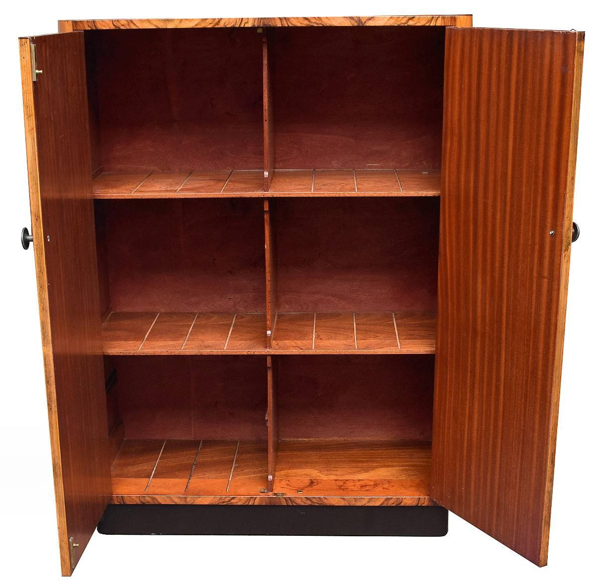 Very attractive and functional piece of furniture that oozes quality. This is an Art Deco cupboard, very generously sized interior for all your needs. Sectioned into six spaces but could be adapted to add further sections perhaps for filing.