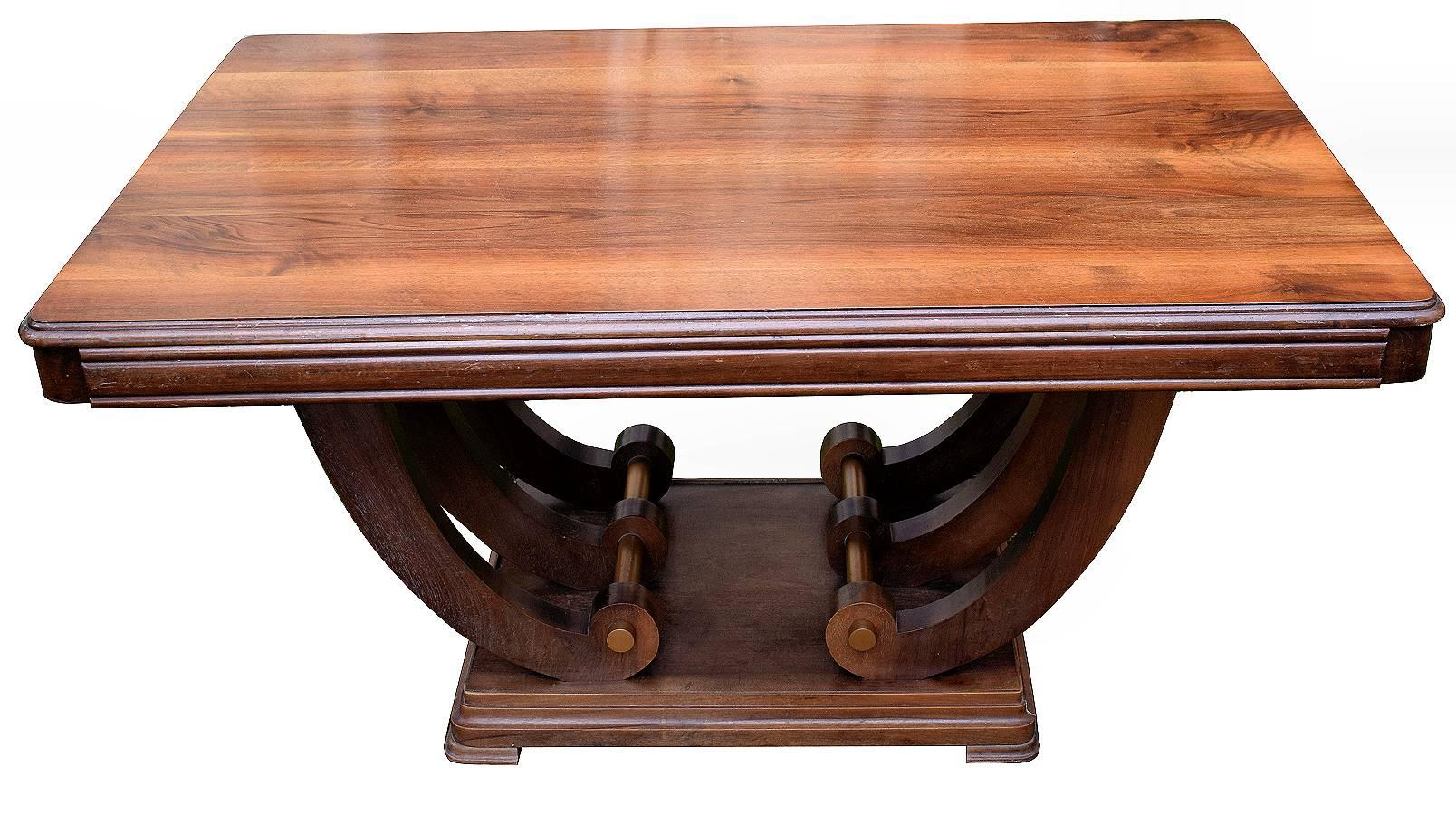Fabulous and ironically shaped 1930s Art Deco walnut U-base dining table. A treble stretcher U-base supports a one piece walnut top. Comfortably seats six people. Would also work as a desk. Condition is excellent having been professionally restored