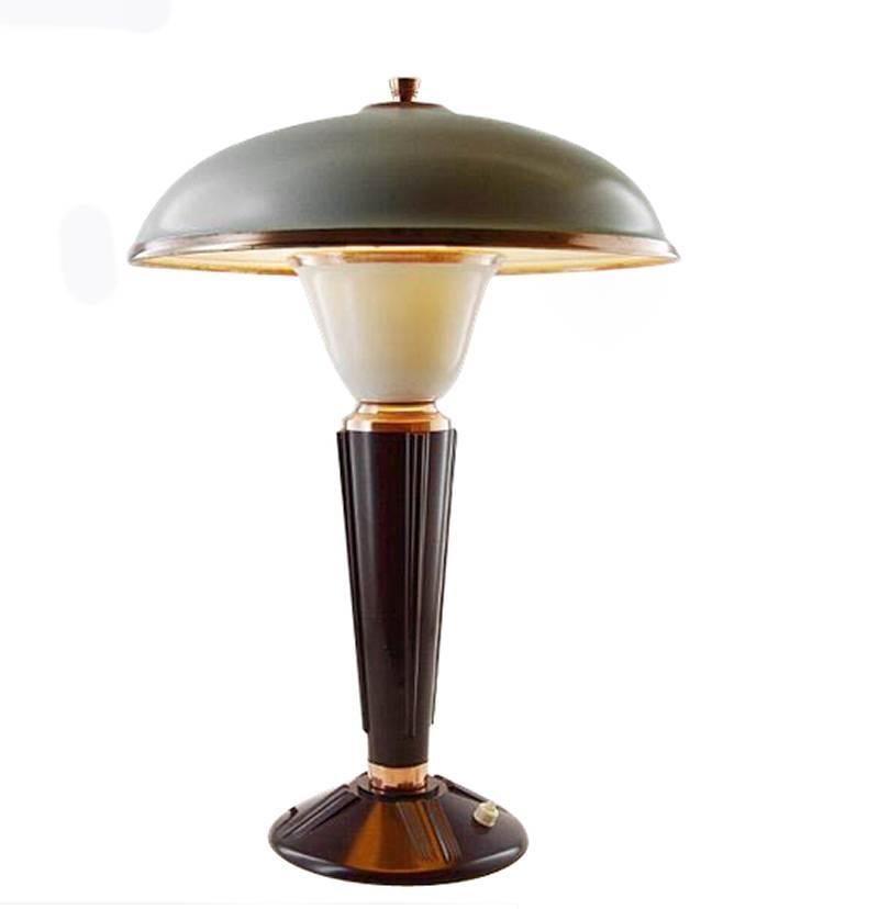 Designed by Eileen Gray for the French Jumo company and dating to the 1930s-1940s this very stylish lamp is made from two primary components which are bakelite and metal. Superb mushroom shape enameled metal shade with copper accents and finial.