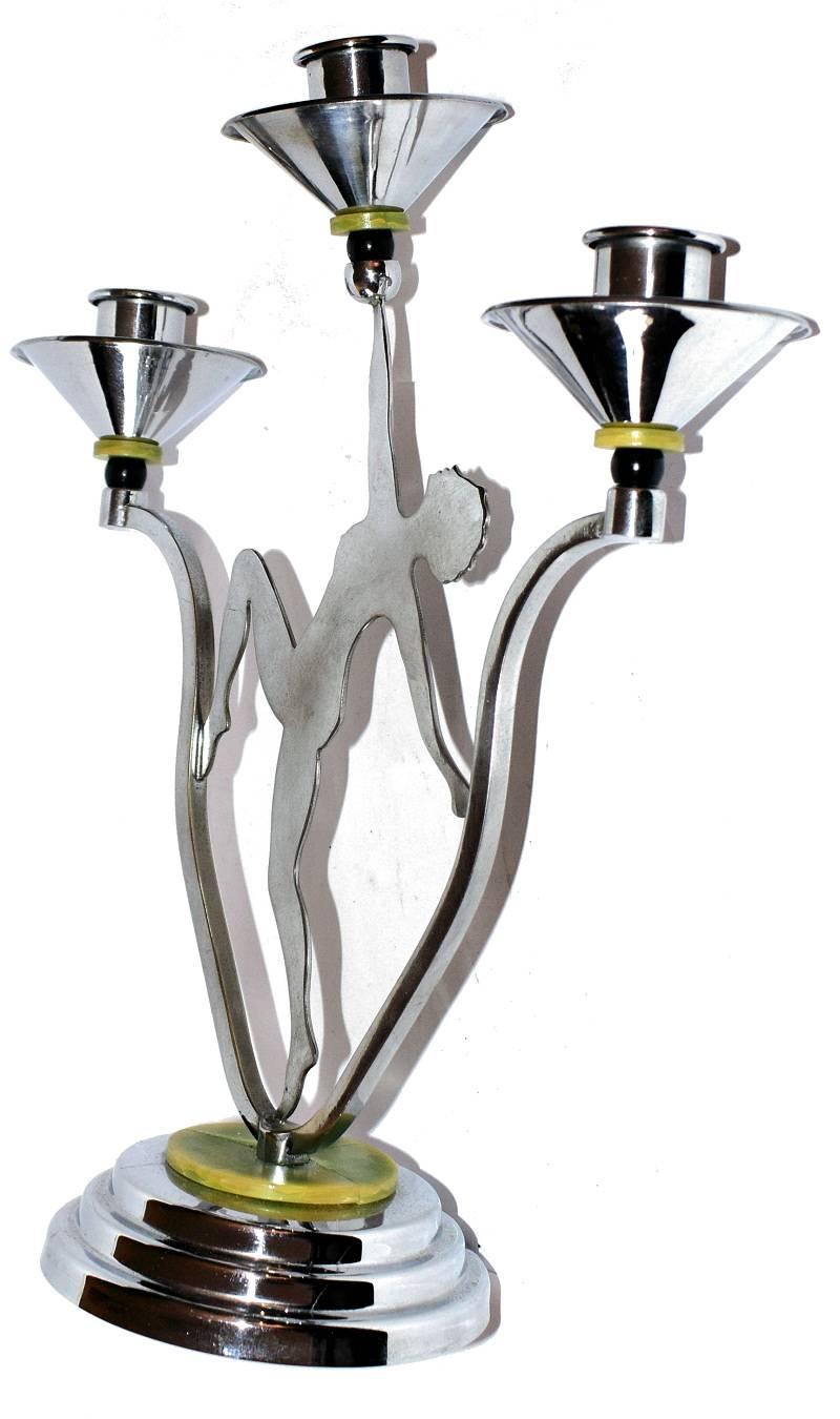 1930s English Art Deco chrome candelabra depicting a silhouette of a female in a dance pose. Bakelite accents to the candleholders and base.