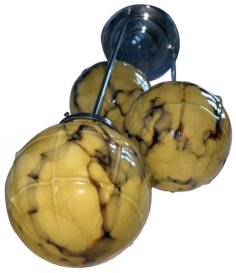 Wonderfully stylish 1930s Art Deco ceiling light. Features three suspended glass shades on the end of chrome poles in a three tiered effect. The shades are beautiful and mint condition, with a very attractive marbling effect that looks as attractive