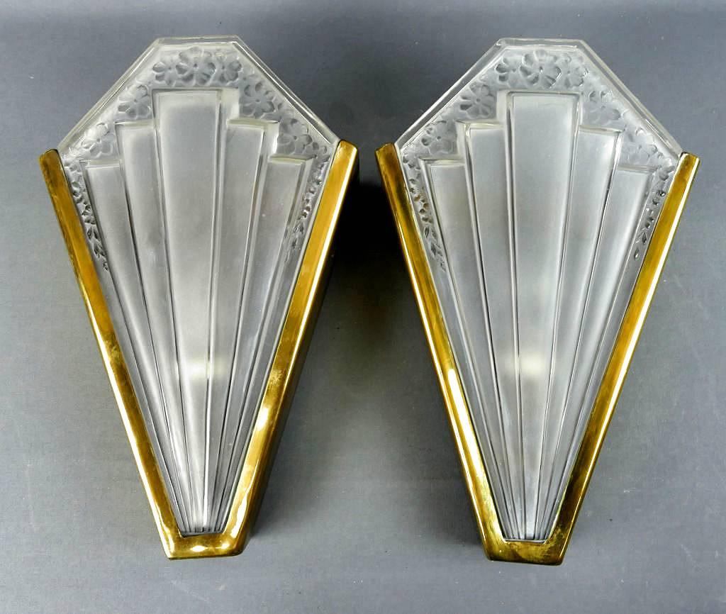 Wonderful pair of Art Deco wall lights, quite substantial and weighty. Sourced in Belgium they have their original screw thread bulb holders made from porcelain. The deep brass wall bracket holds the thick, cast, insertable frosted glass panes which