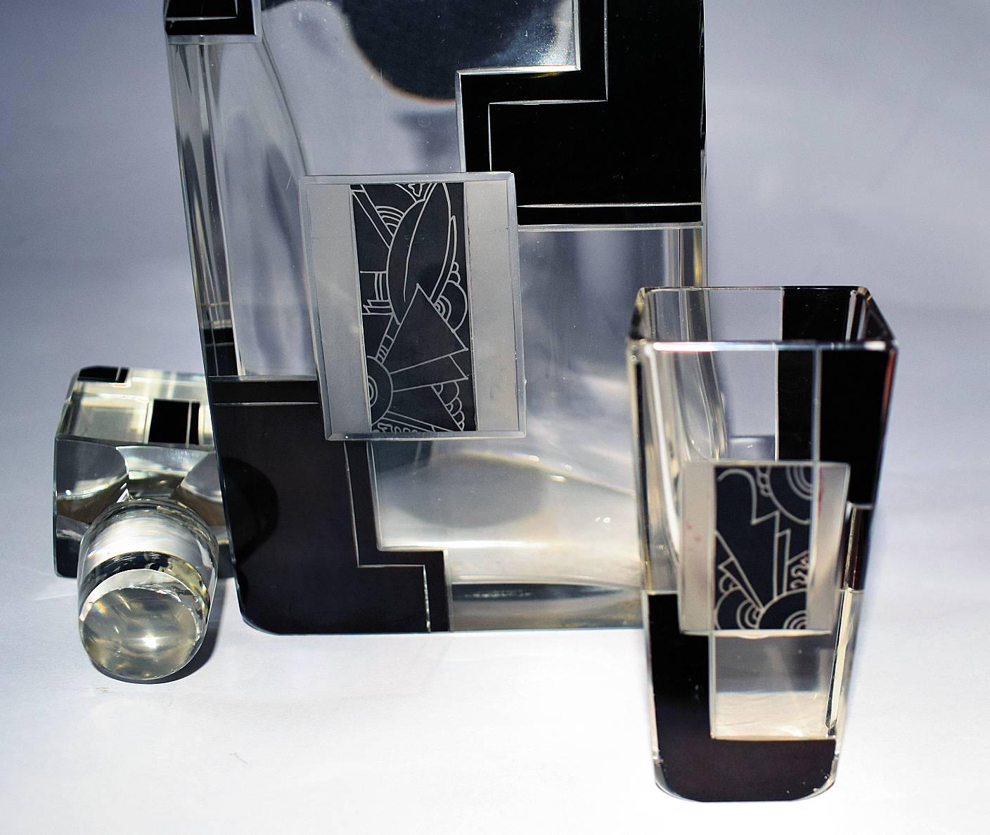 Very stylish Art Deco decanter set comprising decanter and glasses. Please not the tray shown is not part of this sale but can be purchased separately. Huge cut-glass decanter and six oblong shaped glasses. The decanter is deceptively heavy and is