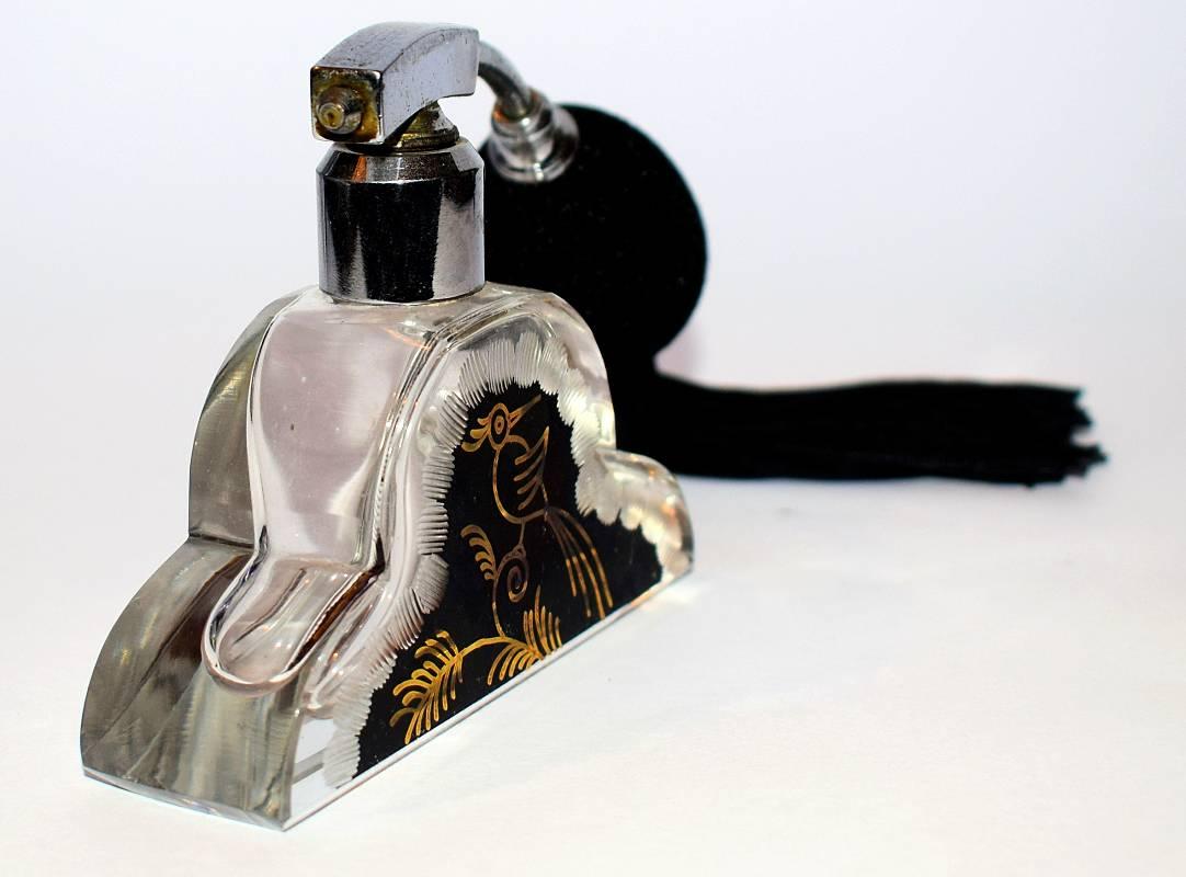A delightful and original Art Deco glass scent bottle, possibly Czech or Bohemian. Great shape with a cut bird design with black and gold enamel color background. Chrome fitting atomizer type with tassel and bulb. Glass and chrome in very good