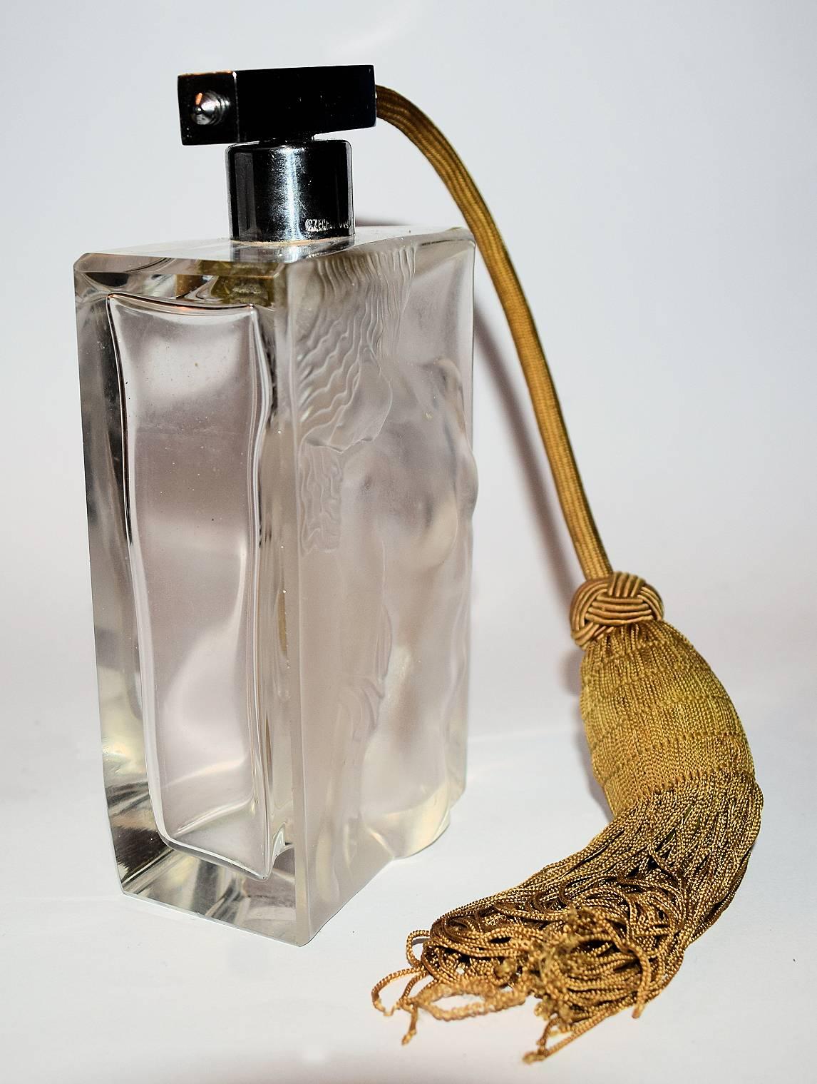 Wonderful and original 1930's Art Deco Czechoslovakian clear frosted glass perfume bottle with embossed nude female decorative motif. In great condition. Stands 17 cm high, so much larger than normal and comes with it's original puffer and tassel.
