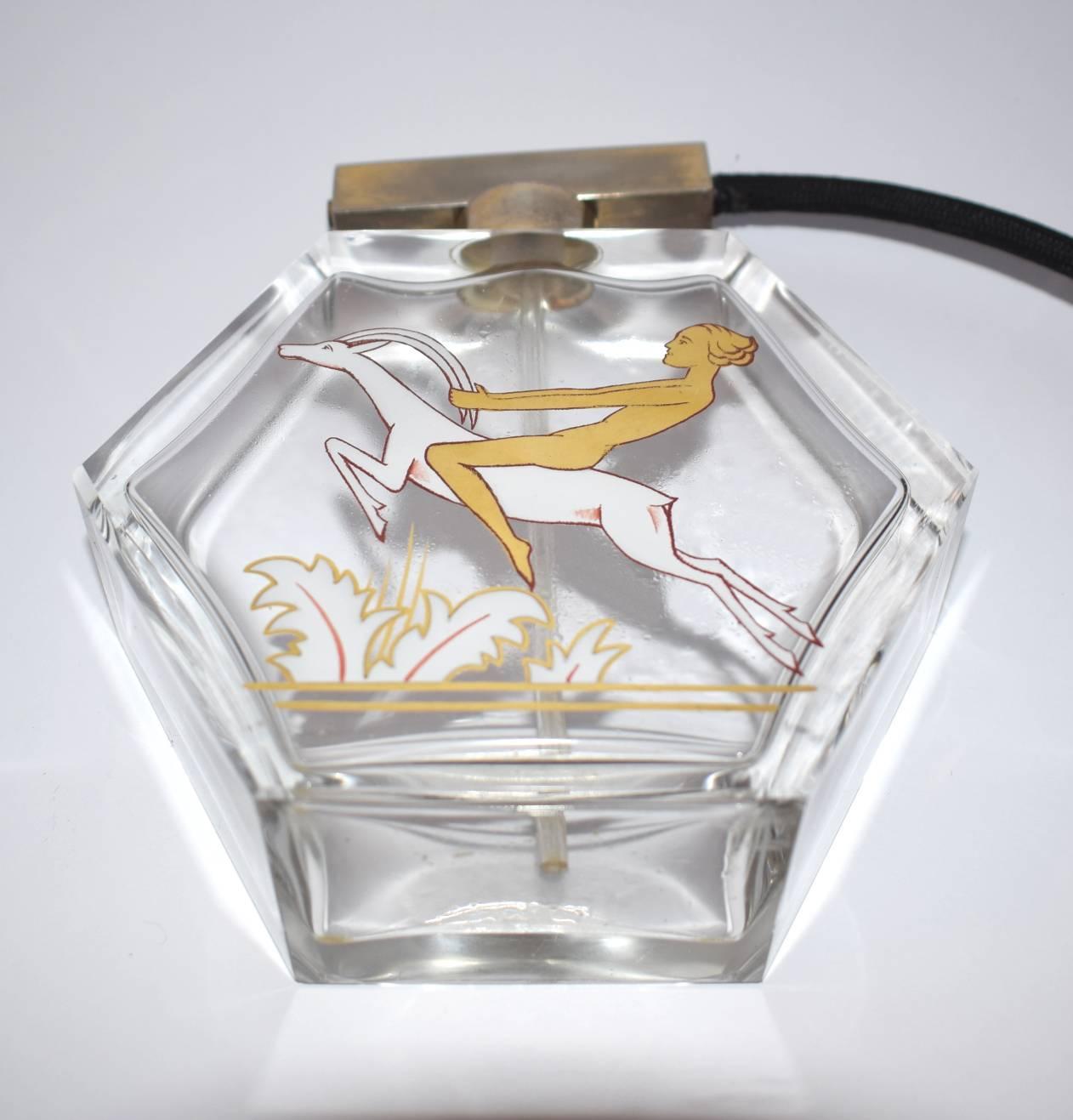 Very attractive and totally authentic 1930s Art Deco Perfume atomizer. Features a nude female leaping over some foliage on the back of a stag which is painted in gold and white. Original black tassel which is good condition. Large size so looks