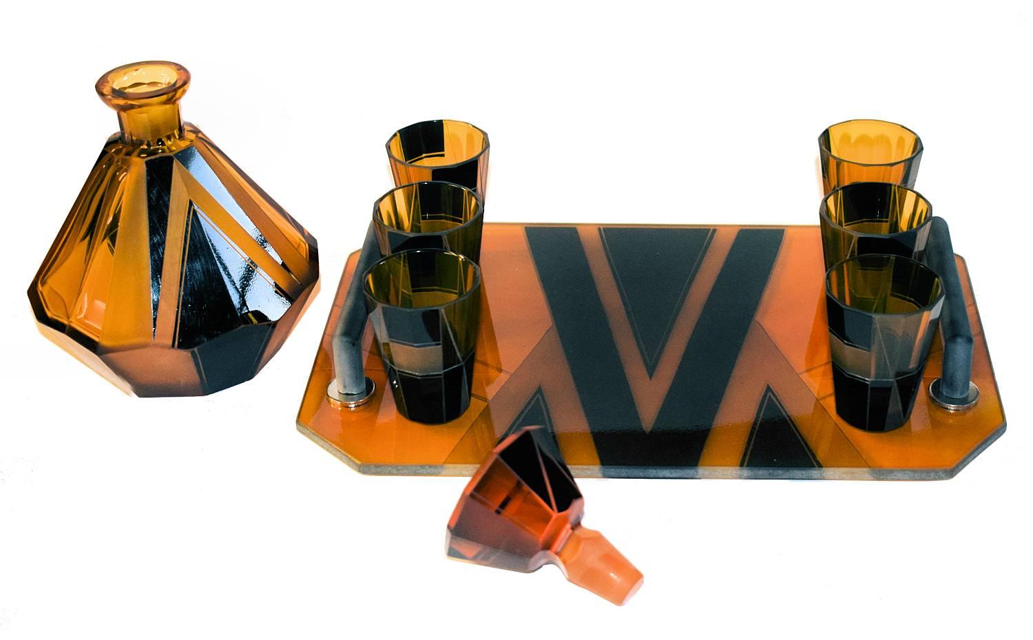 Wonderfully stylish 1930s Art Deco glass decanter set in a warm amber colour with black geometric enamel decoration. Originates from the Czech Republic. This wonderful set is deceptively heavy and shows signs of real quality. The whole set is in