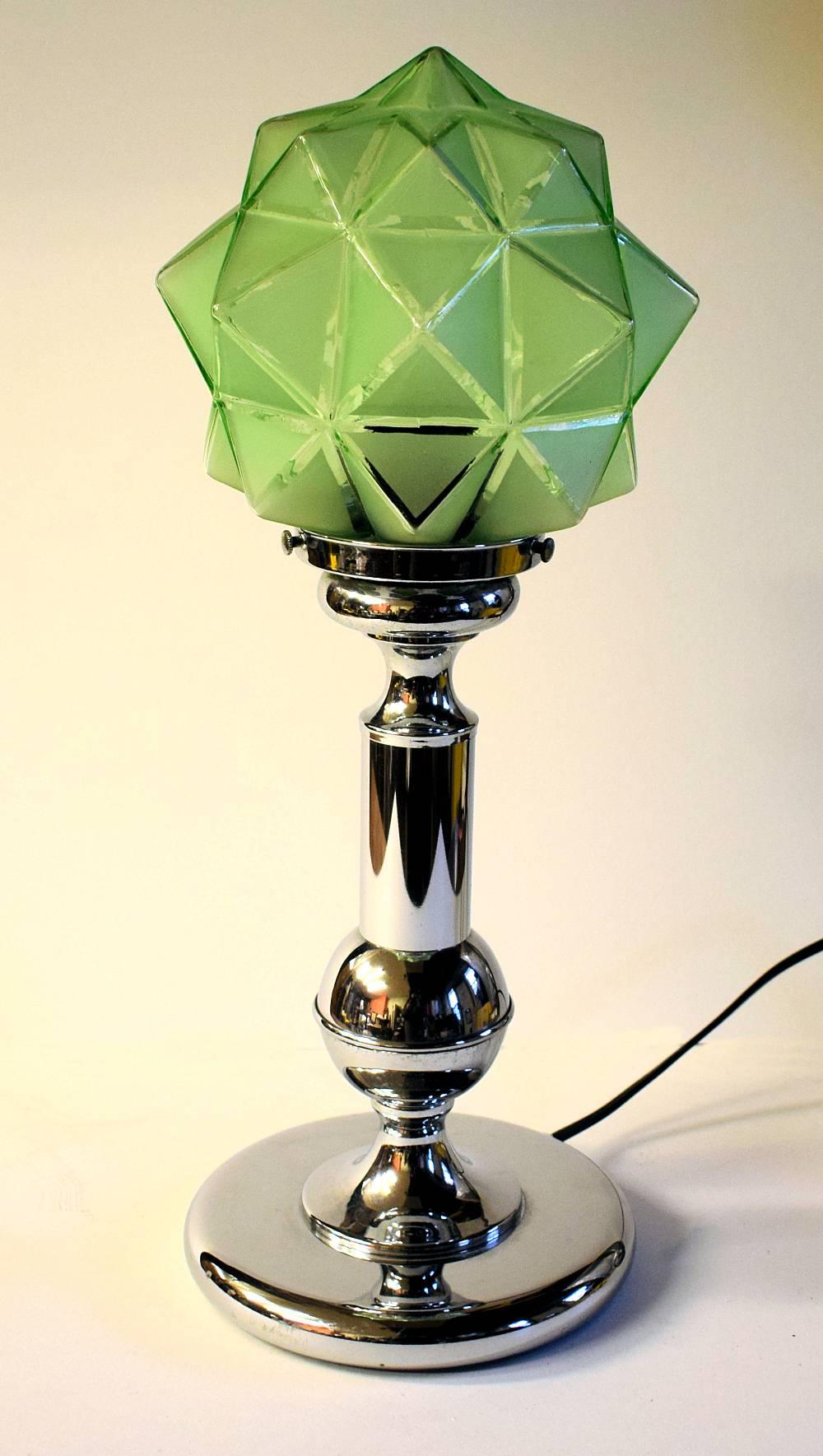 This is an awesome looking 1930s Art Deco table lamp. It features a chrome base and column which supports a wonderful glass shade in a mint green color. These shades are extremely rare and so we were delighted to have sourced this beauty. This lamp