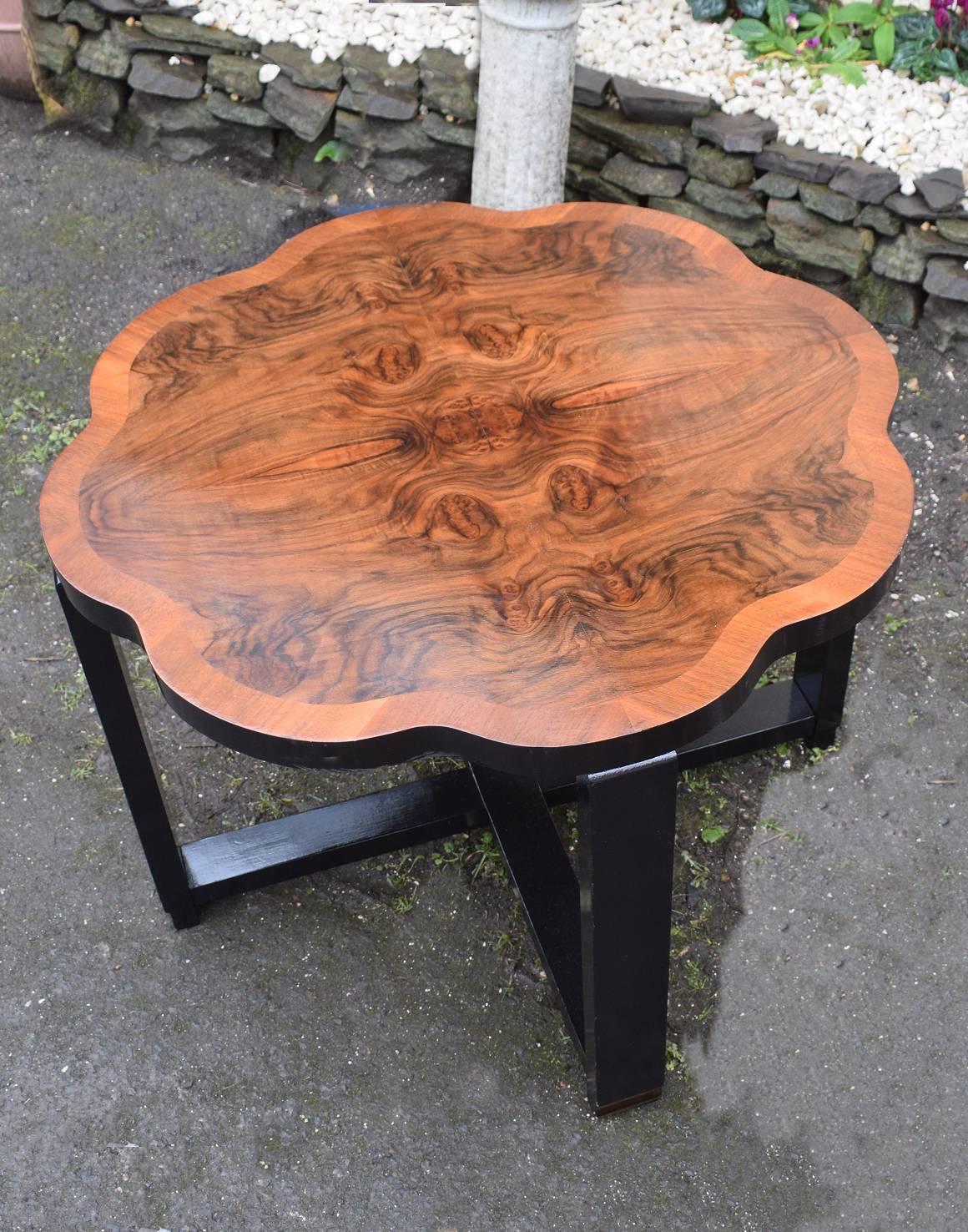 A very stylish 1930s English Art Deco centre table. One large centre table with scalloped edges and ebonised legs and central stretcher with the most exquisite warm walnut veneers. A rare classic piece to enhance your home interior. Fully restored