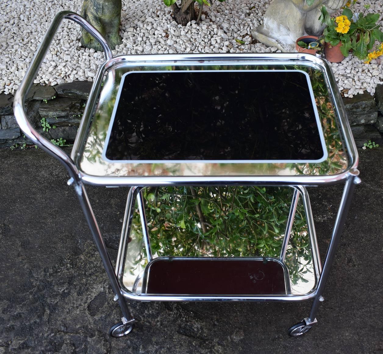 Now this really is a fabulous hostess trolley! Original 1930's Art Deco chrome two-tier trolley, with black and mirrored edged glass, very glam! All totally original and in great condition. These are fab for displaying cocktail shakers, glass and