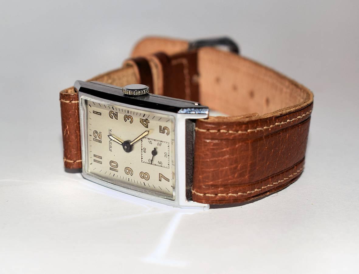 For your consideration is this very stylish Art Deco 1930's mens tank  watch made by Provita and Swiss company. Beautiful condition through out, the chrome is as good as you could hope for. The dial shows little to no signs of it's age. Has a
