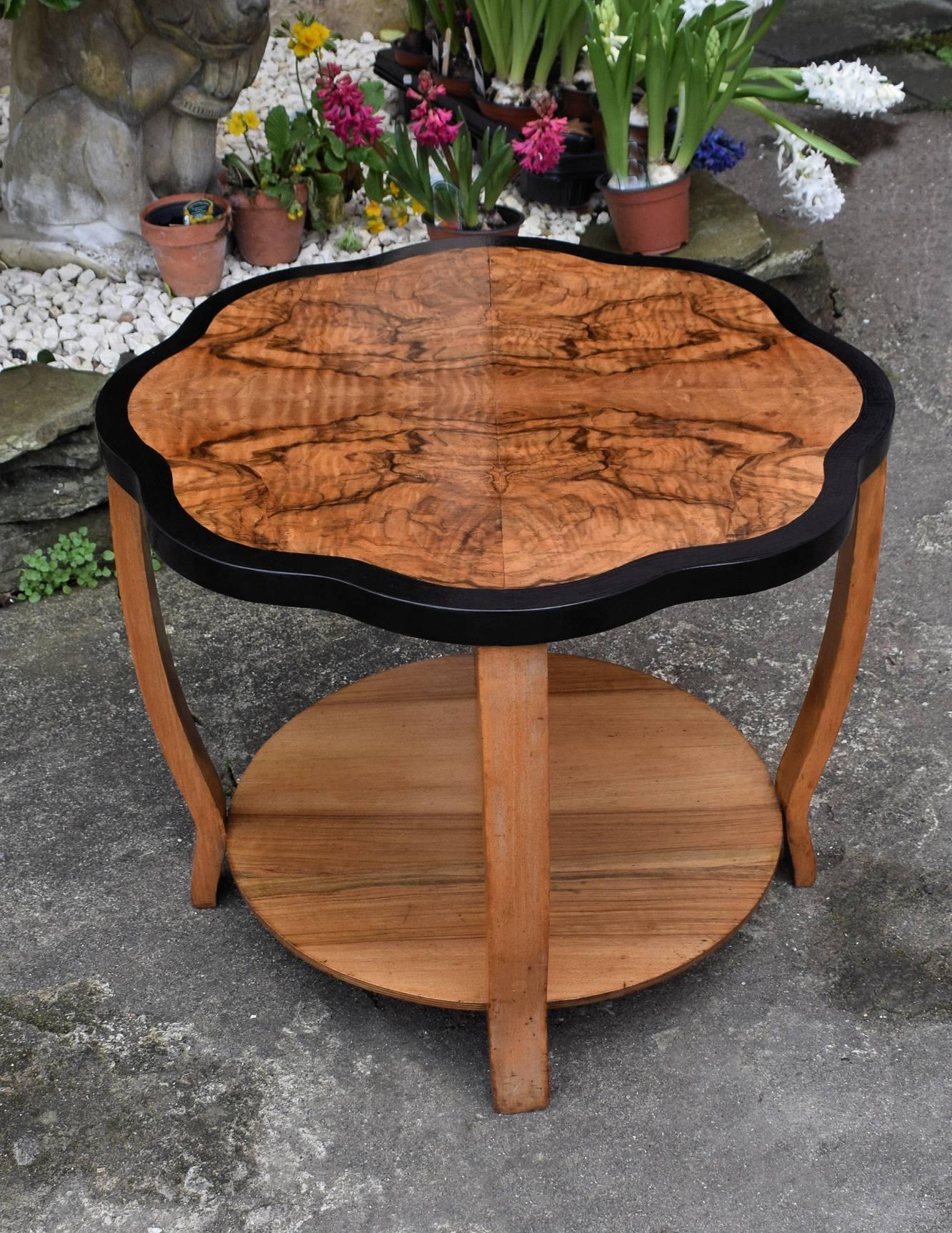This is a stunning looking table with superb Deco design and shape. Ideal size for modern day use and a easily integrated for most rooms. Light tone highly figured walnut veneers, with ebonised edging beautifully shows off the scalloped top. We've
