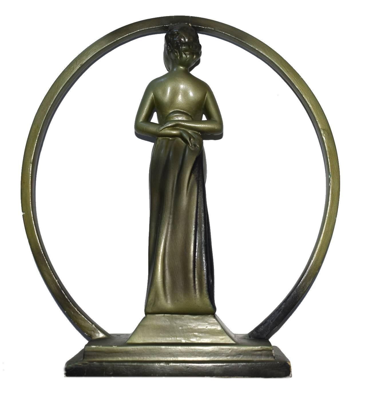 An original Art Deco plaster figurine of a nude lady standing in a hoop. The overall height is 12 inches. The figure stands on a stepped base within the hoop and is very well modelled with a beautiful face. There are no makers mark but it is a good