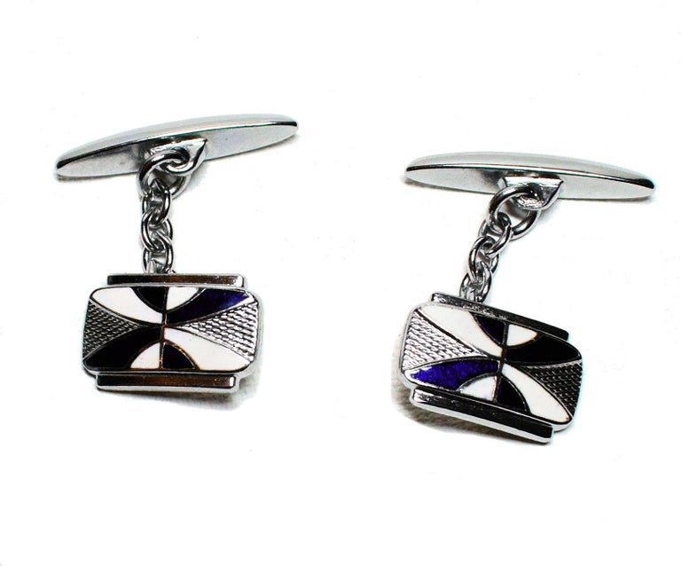 Fabulous pair of matching Art Deco men’s cuff links with a great geometric pattern. Silver toned metal with blue and white enamel decoration. Condition is very good.