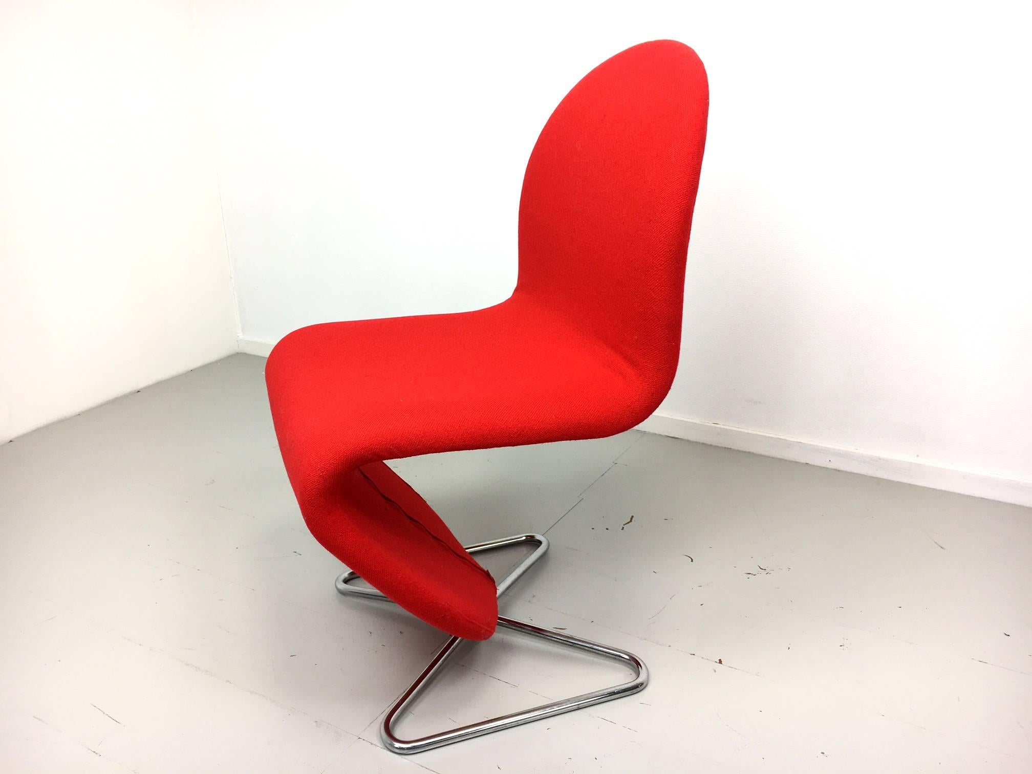 This set of four model system 123 chairs was designed by Verner Panton (Denmark, 1926-1998). They are covered with a red zippered original wool fabric from Kvadrat. The chromed tubular feet are in a butterfly winged shape, unusual for this model.