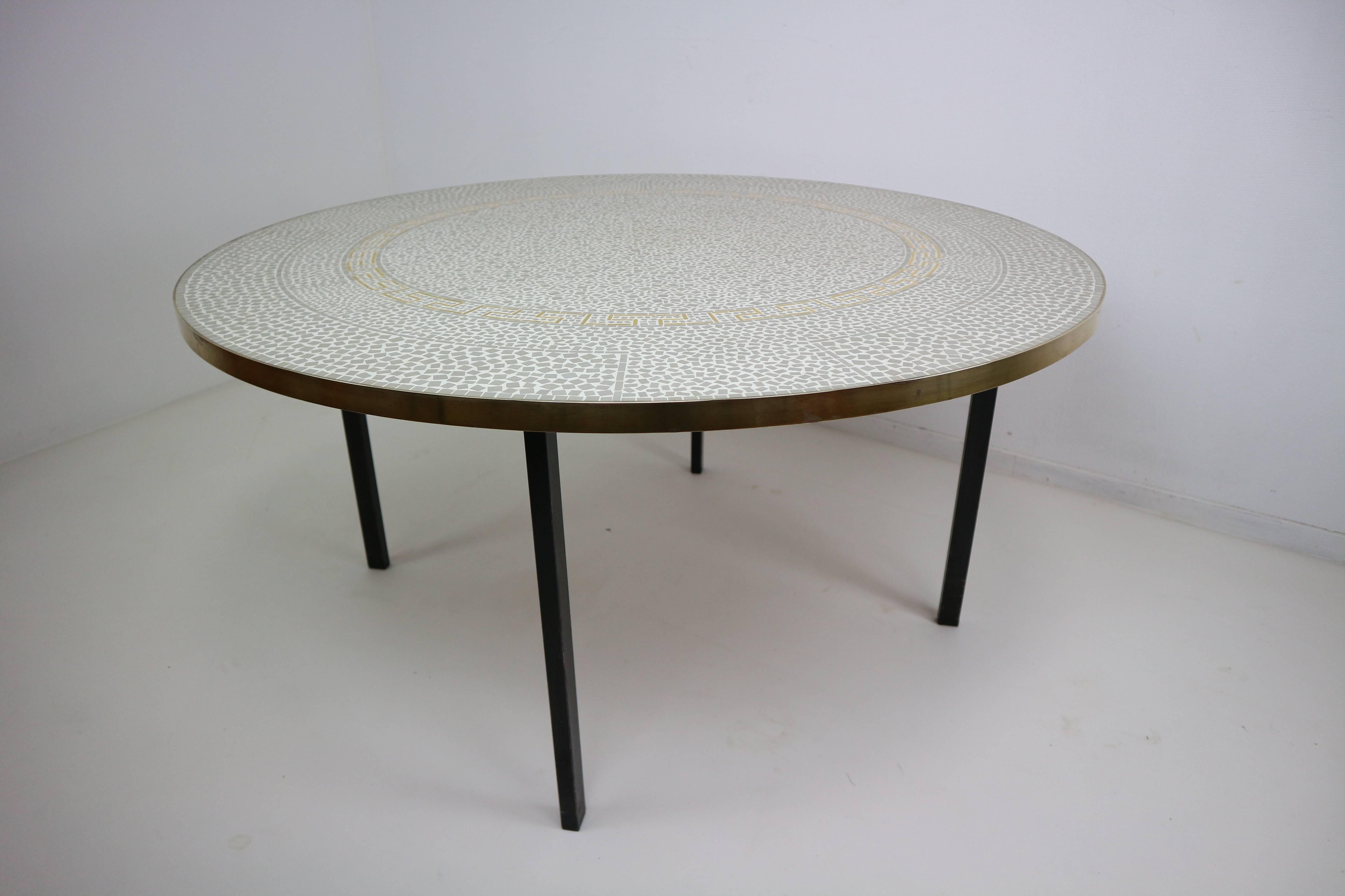 Berthold Muller sculptured circular coffee table.
Mosaic tiles and gold enamels tiles, brass band and metal feet.
The composition of the drawing is of great elegance and rarely encountered.
Very rare to find. Excellent condition.