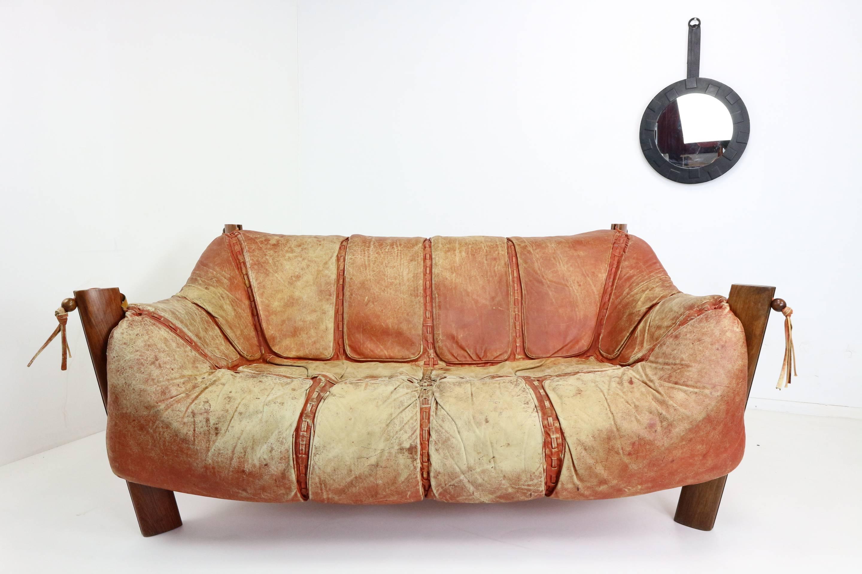 Two-seat sofa by Brazilian designer Percival Lafer. Real leather, in red and the seating hangs in a Jacaranda wood base. Decorated with leather laces which ends in a connection to the frame and the seating, finished with beautiful rosewood