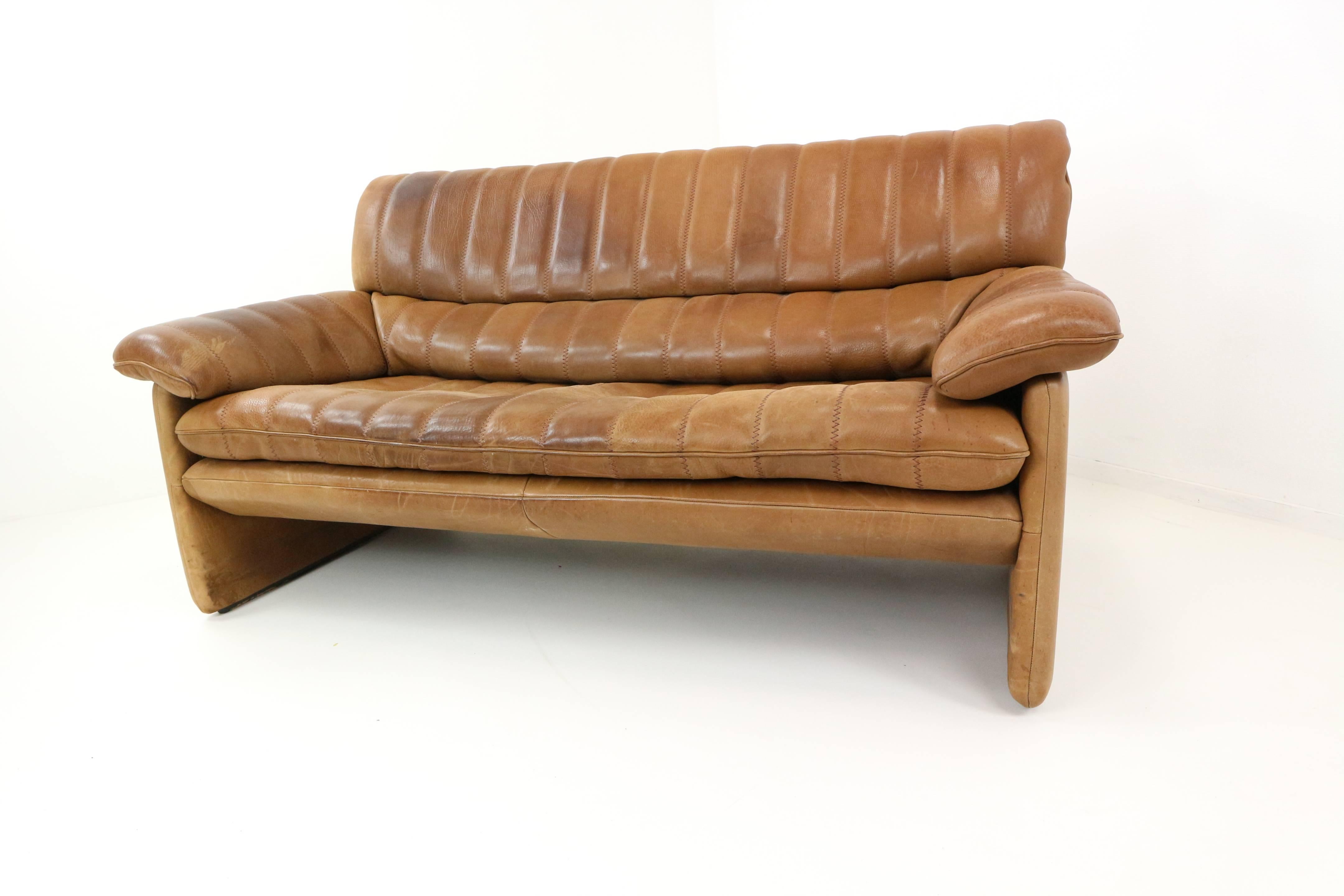 This DS-85 set is consisting of a chair, two-seat sofa and three-seat sofa. The sit-group was manufactured by De Sede in Switzerland in the 1970s. It is upholstered in cognac-colored buffalo leather, the thickest leather in the De Sede collection,