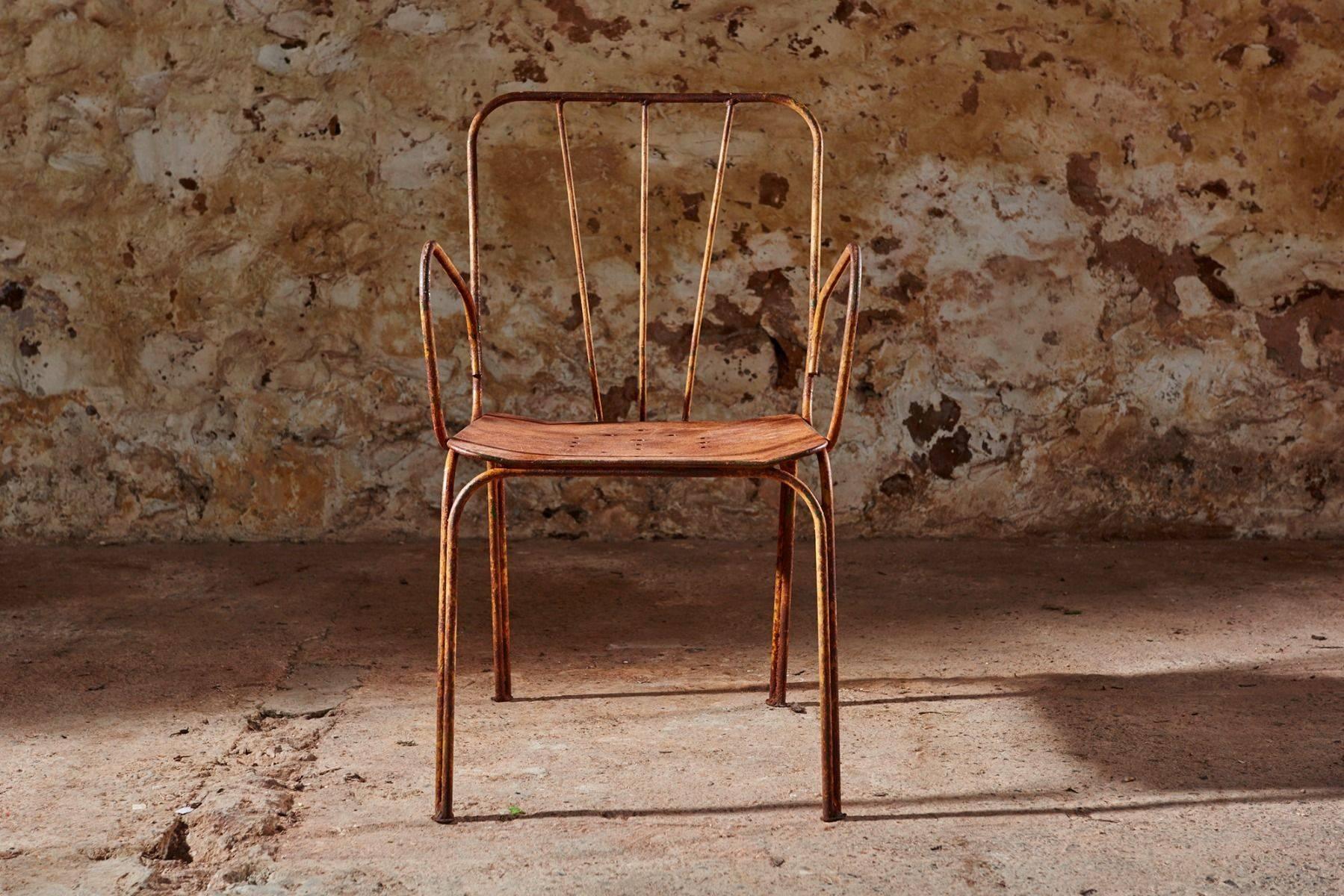 A set of six 1940s garden chairs in the style of Ernest Race. These six wrought iron chairs are in excellent condition, and have an interesting hazelnut brown patina showing remnants of an ochre paint finish.

The chairs have the simple lines