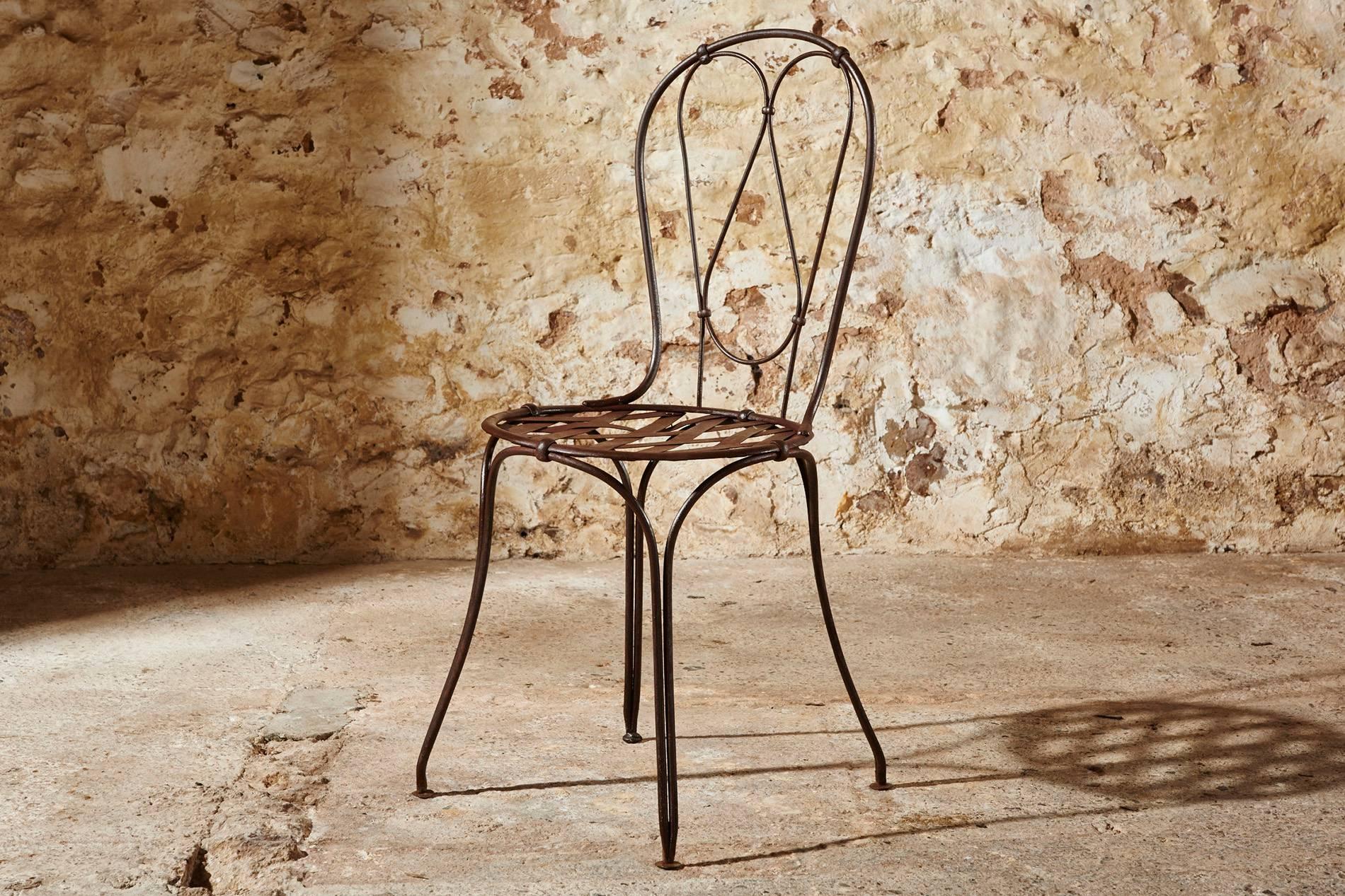 It is very unusual to find a set of ten matching 19th century garden chairs in their original hazelnut brown patina.

They are typically riveted together as manufactured before welding was widely introduced. They have a hand-forged wrought iron