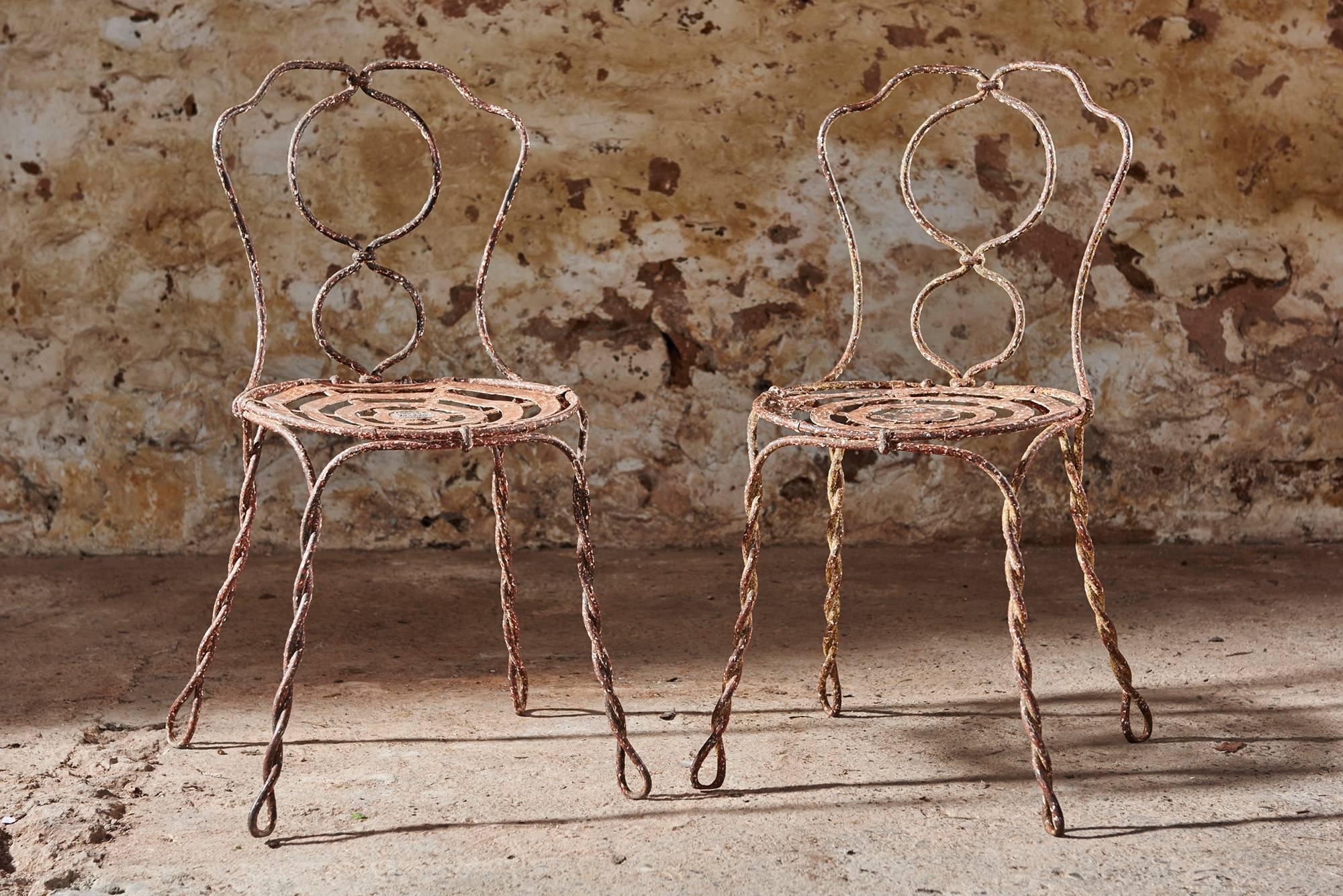 These fantastic and rare Vachon chairs were made in Paris in mid-19th century.
They have a rope style twisted metal frame and a beautiful and original patina. One chair has the manufacturers lead badge in the middle of the seat which is